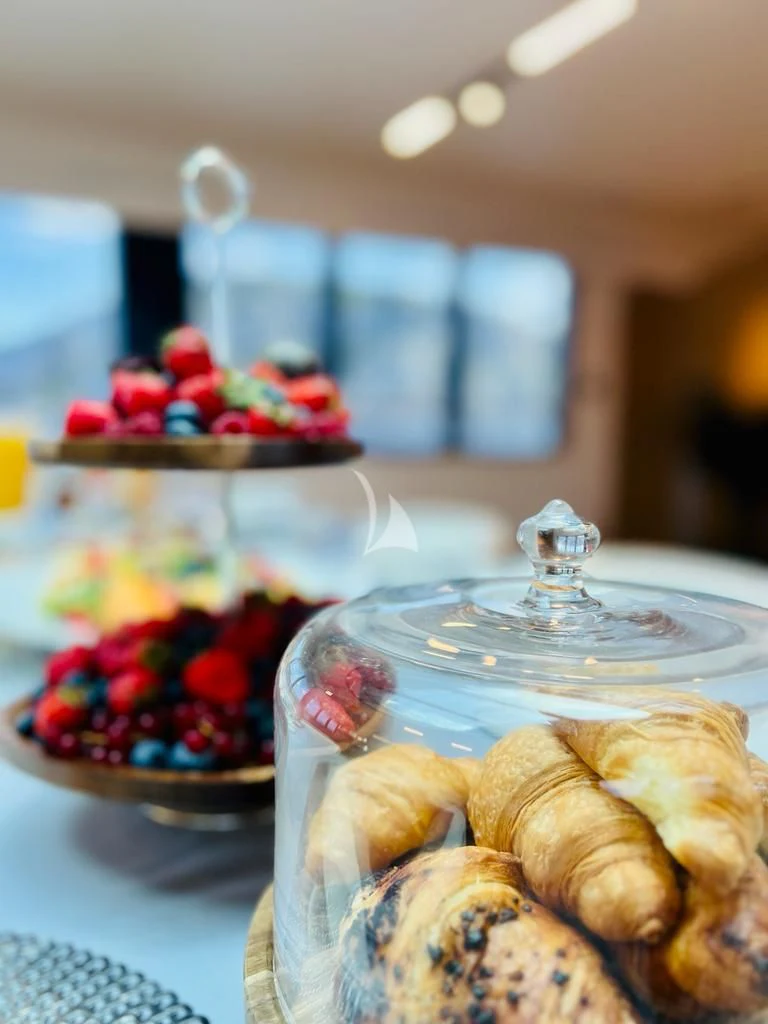 a glass bowl with a glass bowl of fruit and a glass bowl with a candle in it aboard ANETTA Yacht for Charter