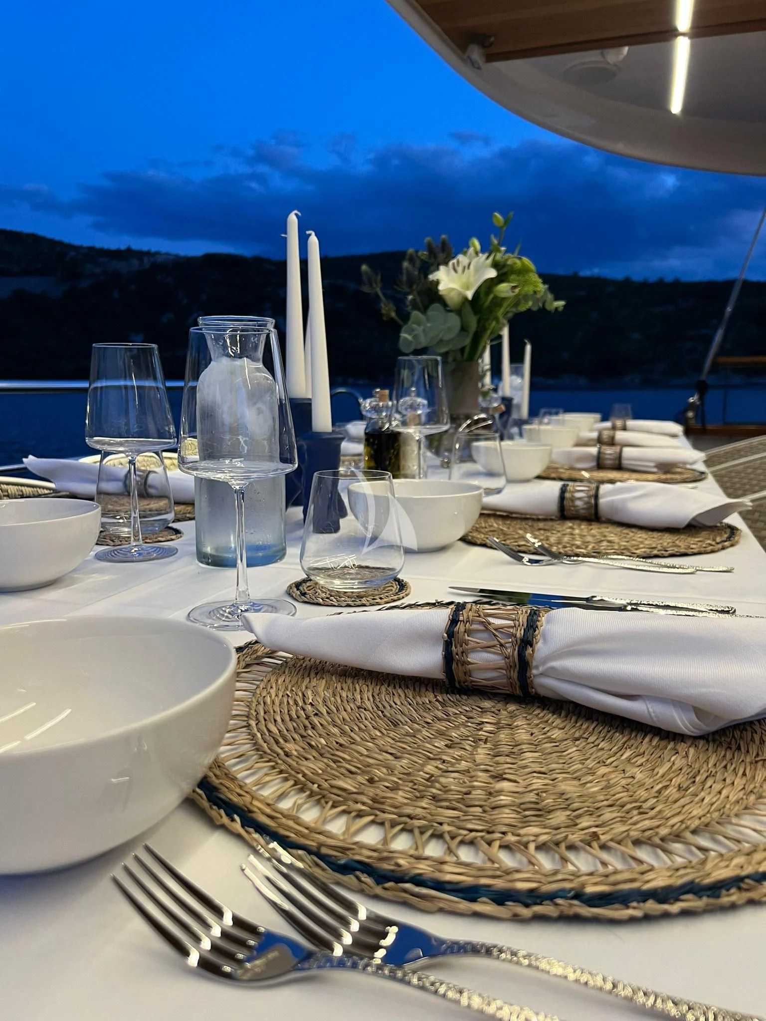 a table with plates and glasses on it aboard ANETTA Yacht for Charter