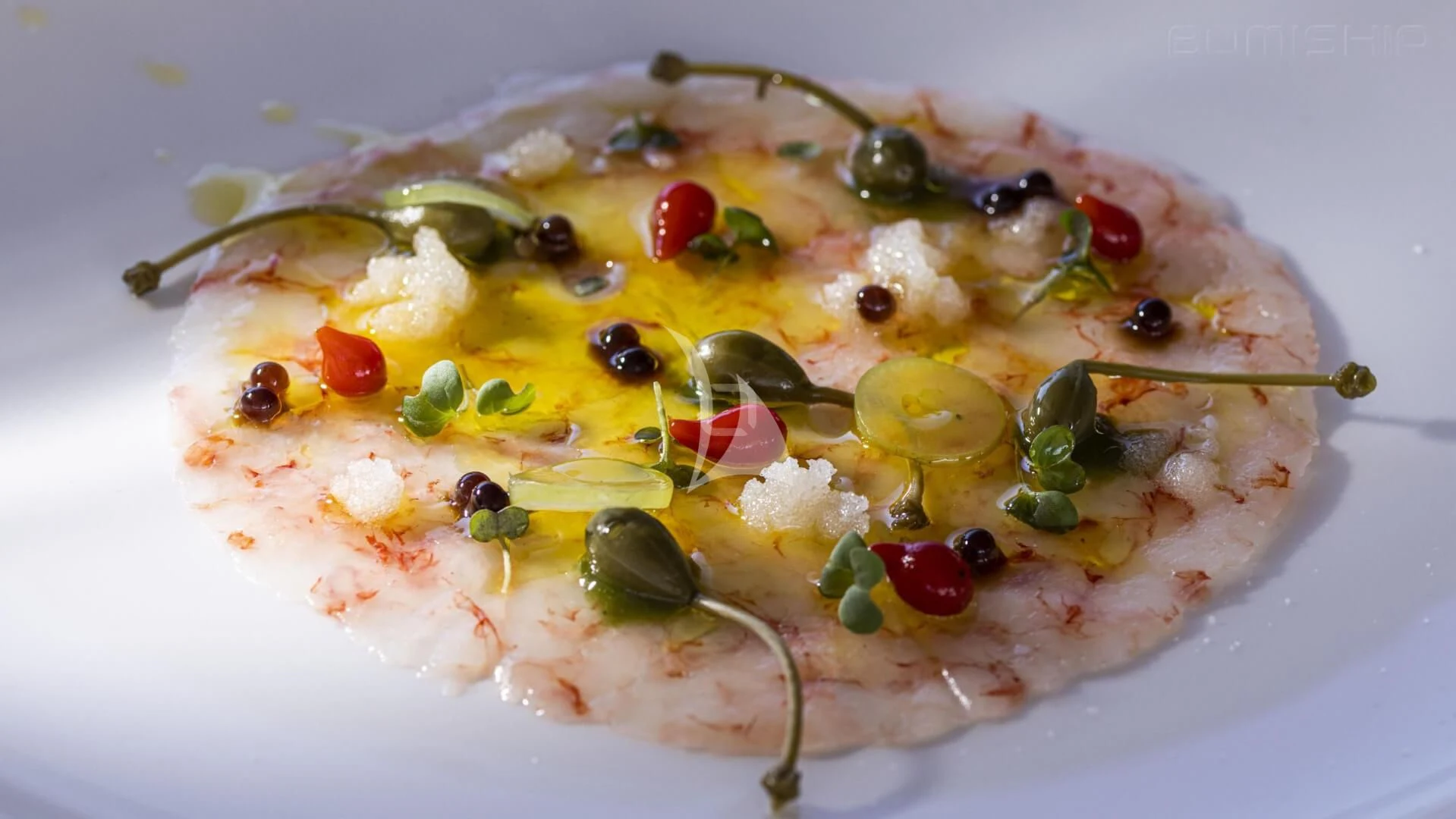 a pizza with olives and tomatoes aboard ANETTA Yacht for Charter