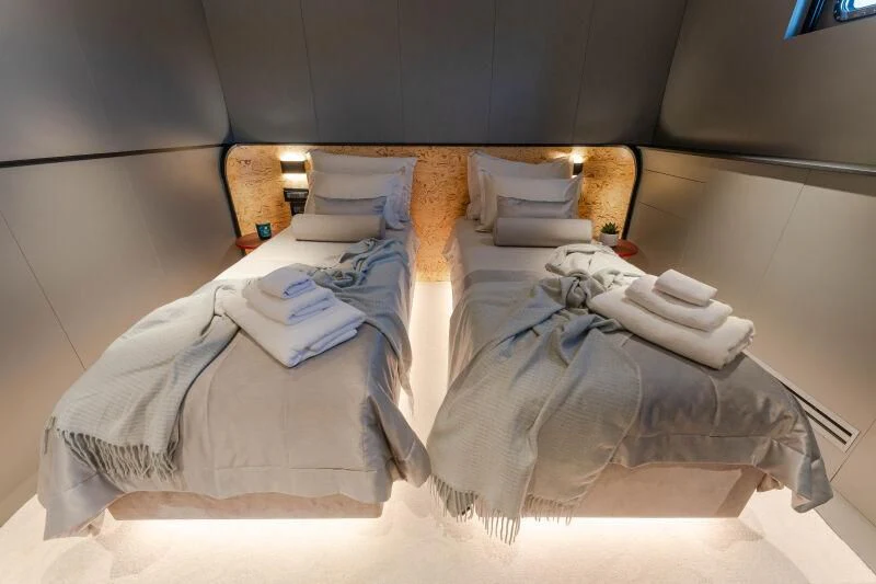 a bed with folded towels aboard ANETTA Yacht for Charter