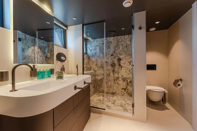 a bathroom with a glass shower aboard ANETTA Yacht for Charter