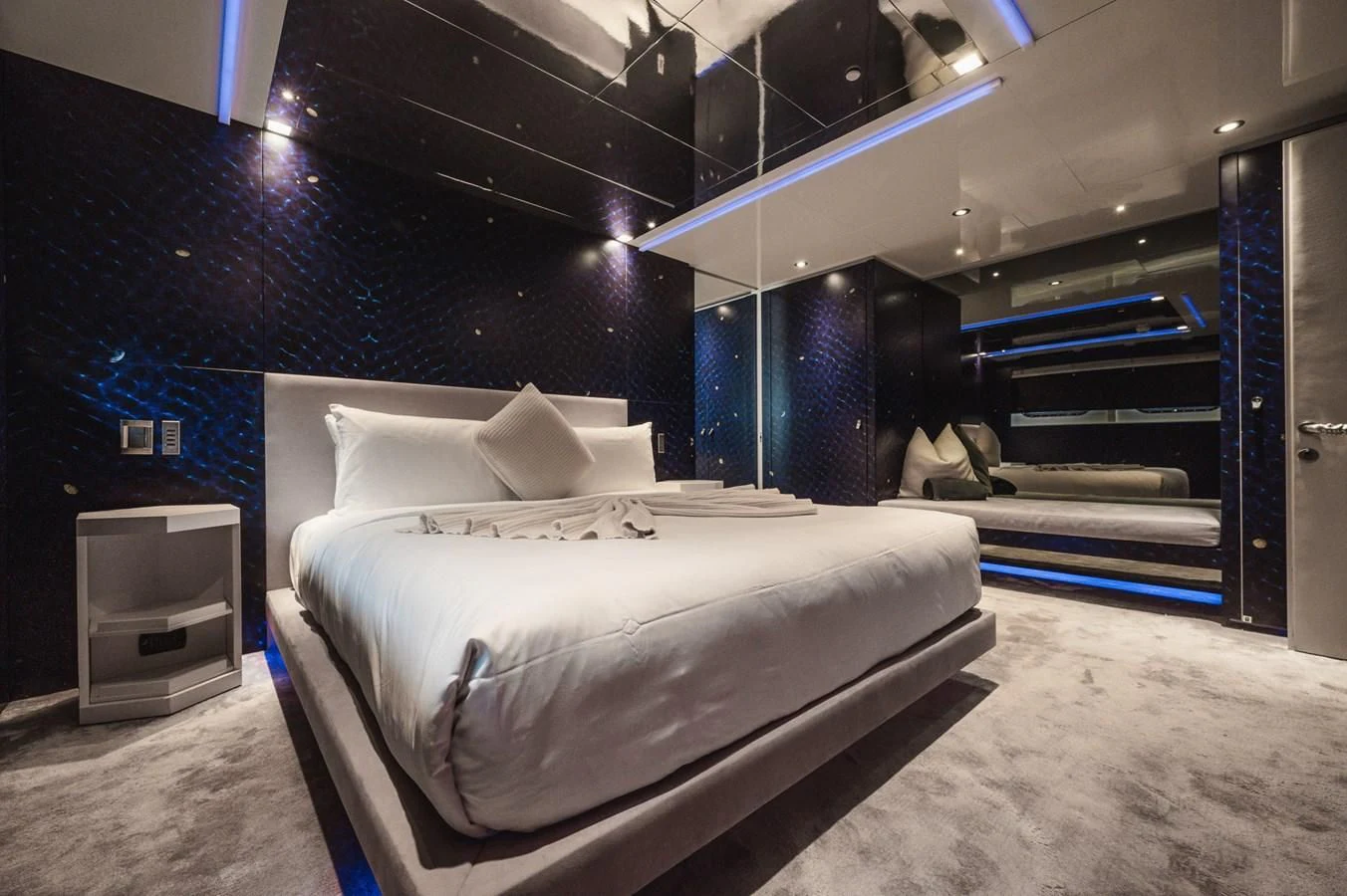 a room with a bed and a large blue wall aboard MAJESTY ELENOLIYA Yacht for Sale