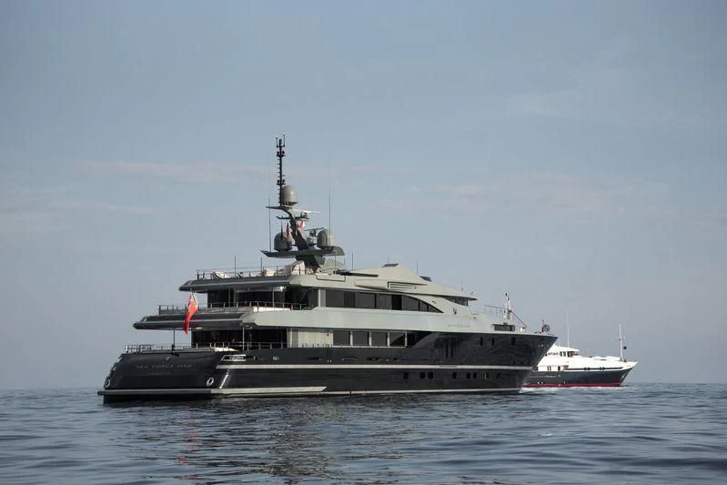 a large ship with a smaller boat in the water aboard MAJESTY ELENOLIYA Yacht for Sale
