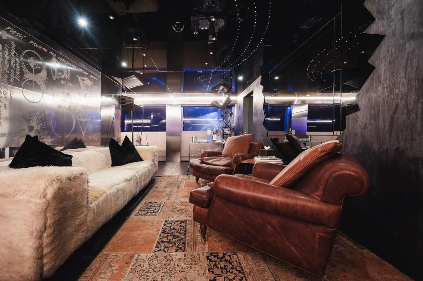 a room with couches and a rug aboard MAJESTY ELENOLIYA Yacht for Sale