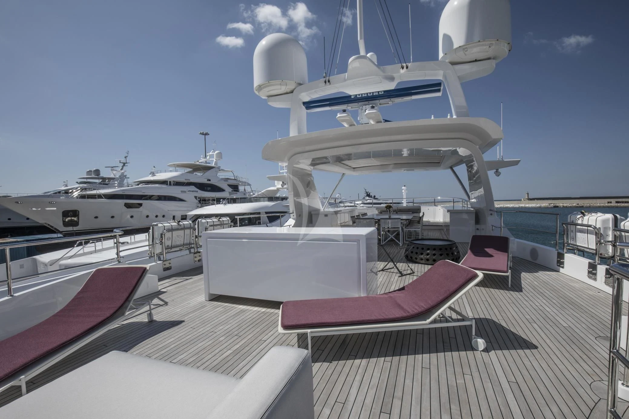 a deck with a boat and a table with chairs on it aboard ALEGRE Yacht for Sale