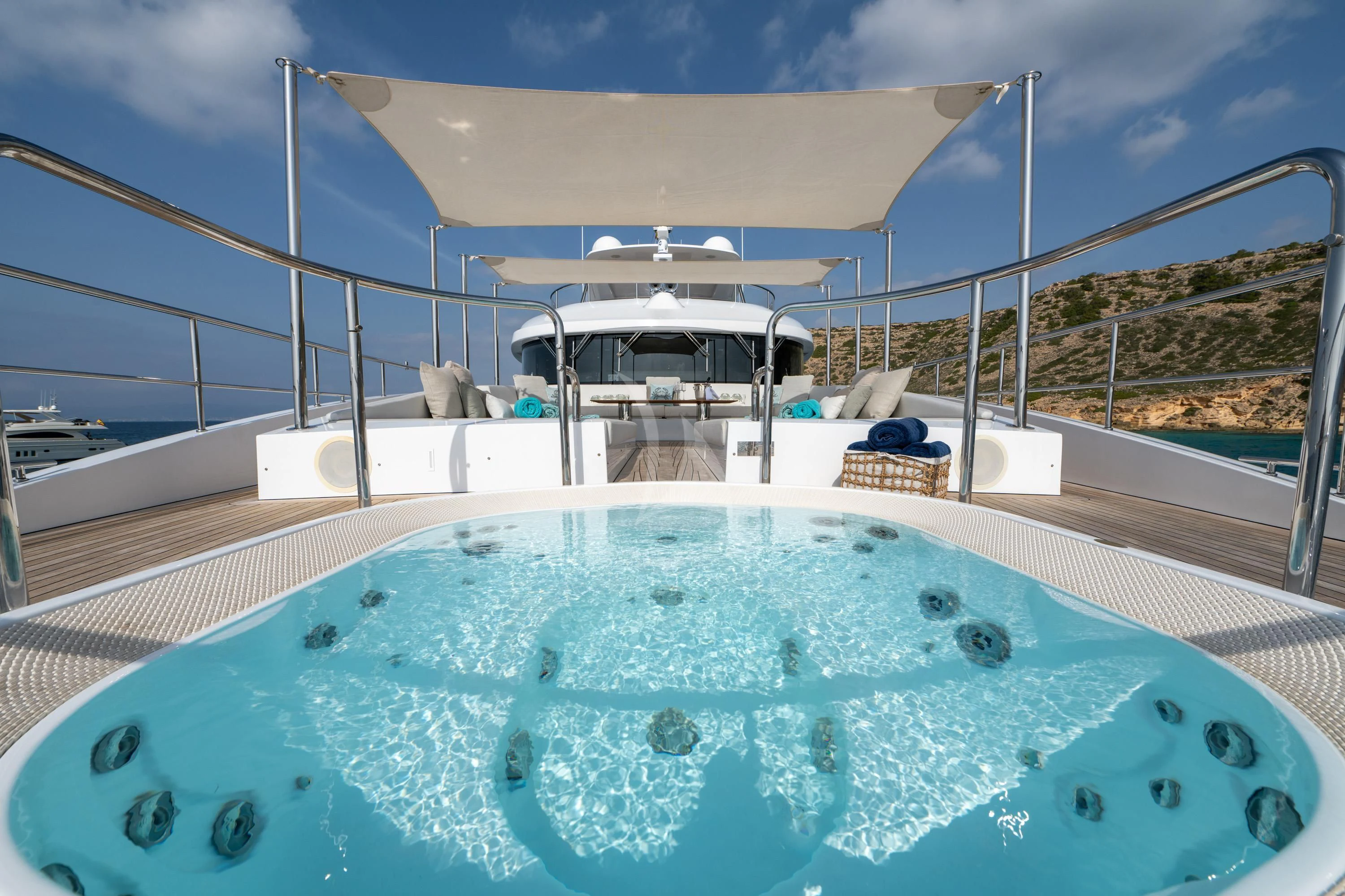 a swimming pool with a large deck and a view of the water aboard ALEGRE Yacht for Sale