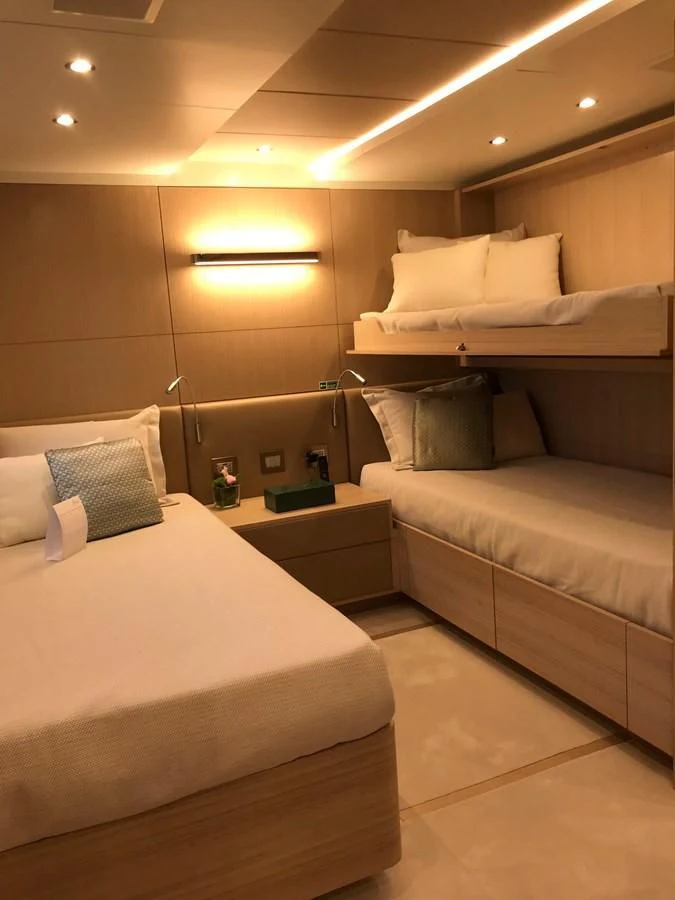 a room with beds and a table aboard ALEGRE Yacht for Sale