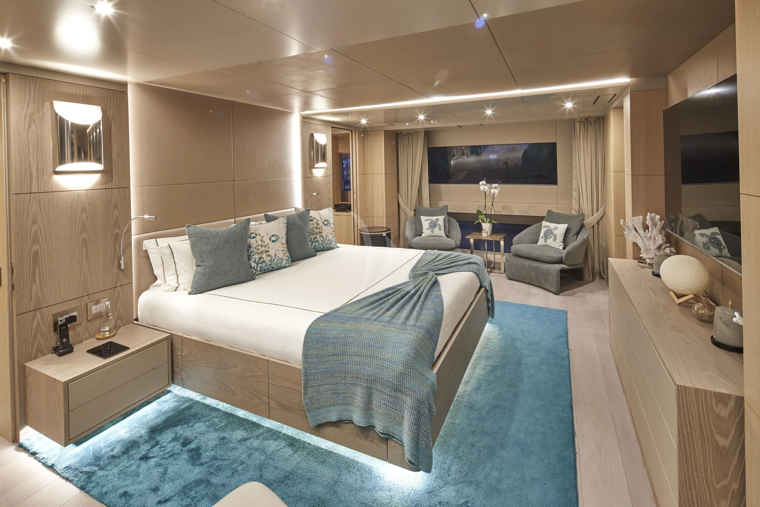 a bedroom with a bed and a chair aboard ALEGRE Yacht for Sale