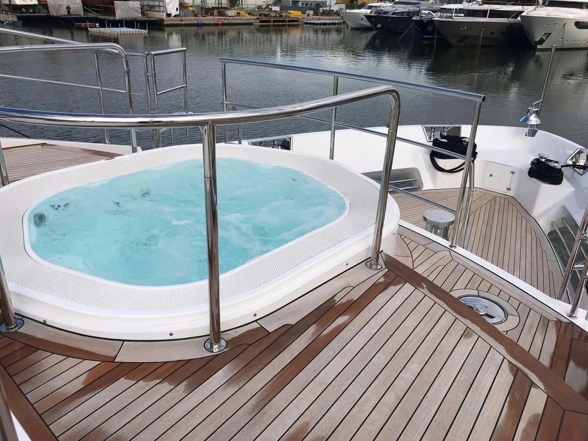 a deck with a pool and a deck with a deck and a large building in the background aboard ALEGRE Yacht for Sale