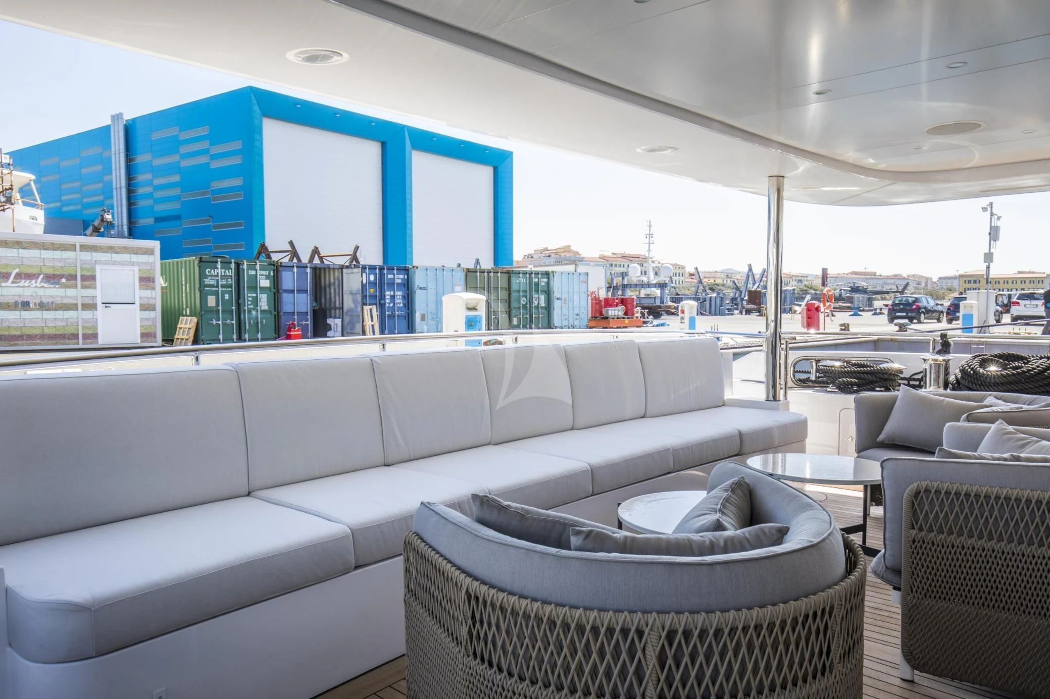 a couch and a table in a room with chairs and a large window aboard ALEGRE Yacht for Sale