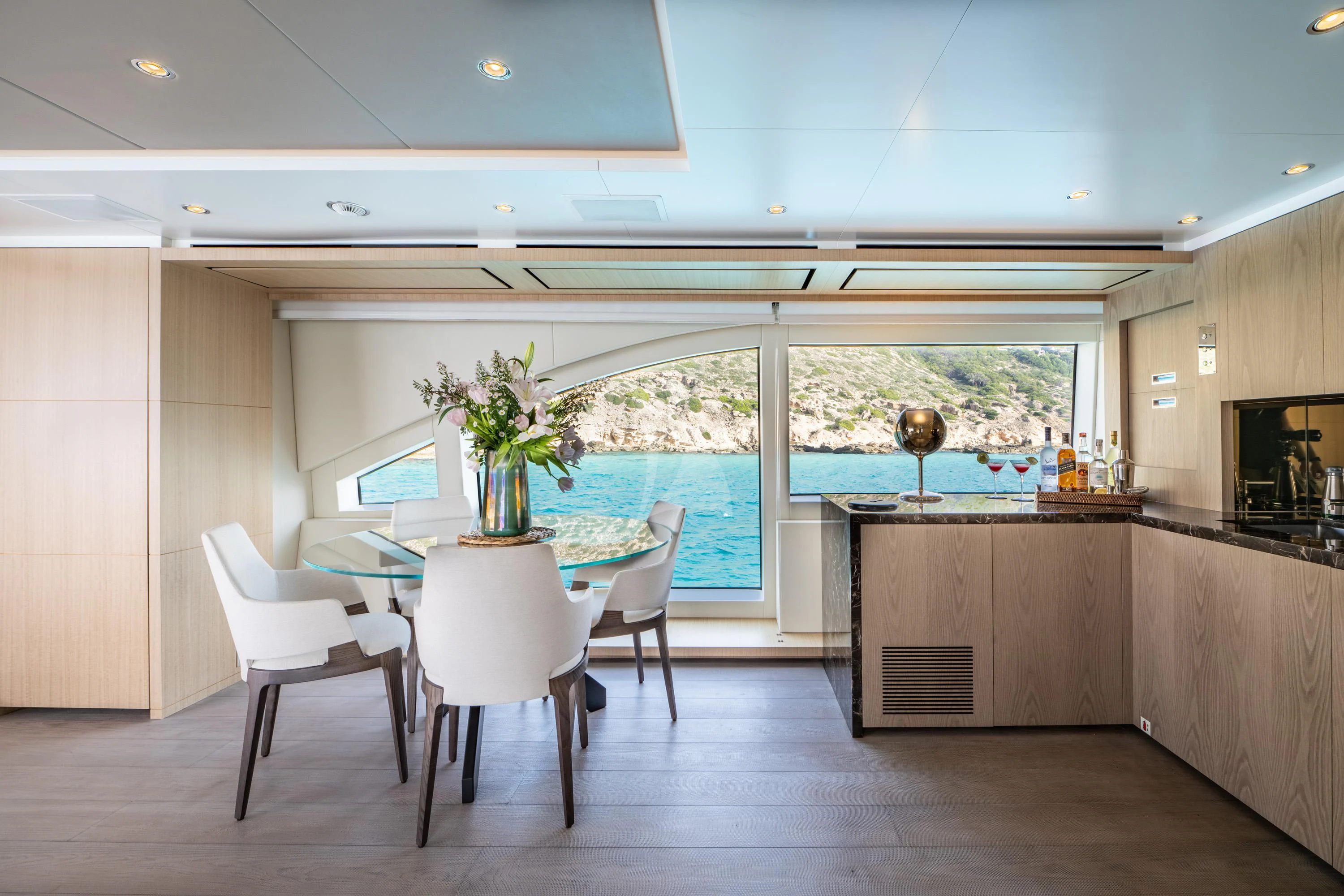 a kitchen with a table and chairs aboard ALEGRE Yacht for Sale