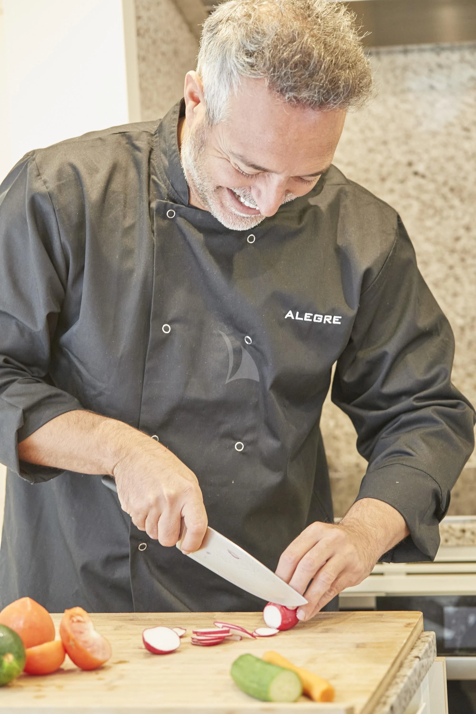 a man cutting vegetables aboard ALEGRE Yacht for Sale