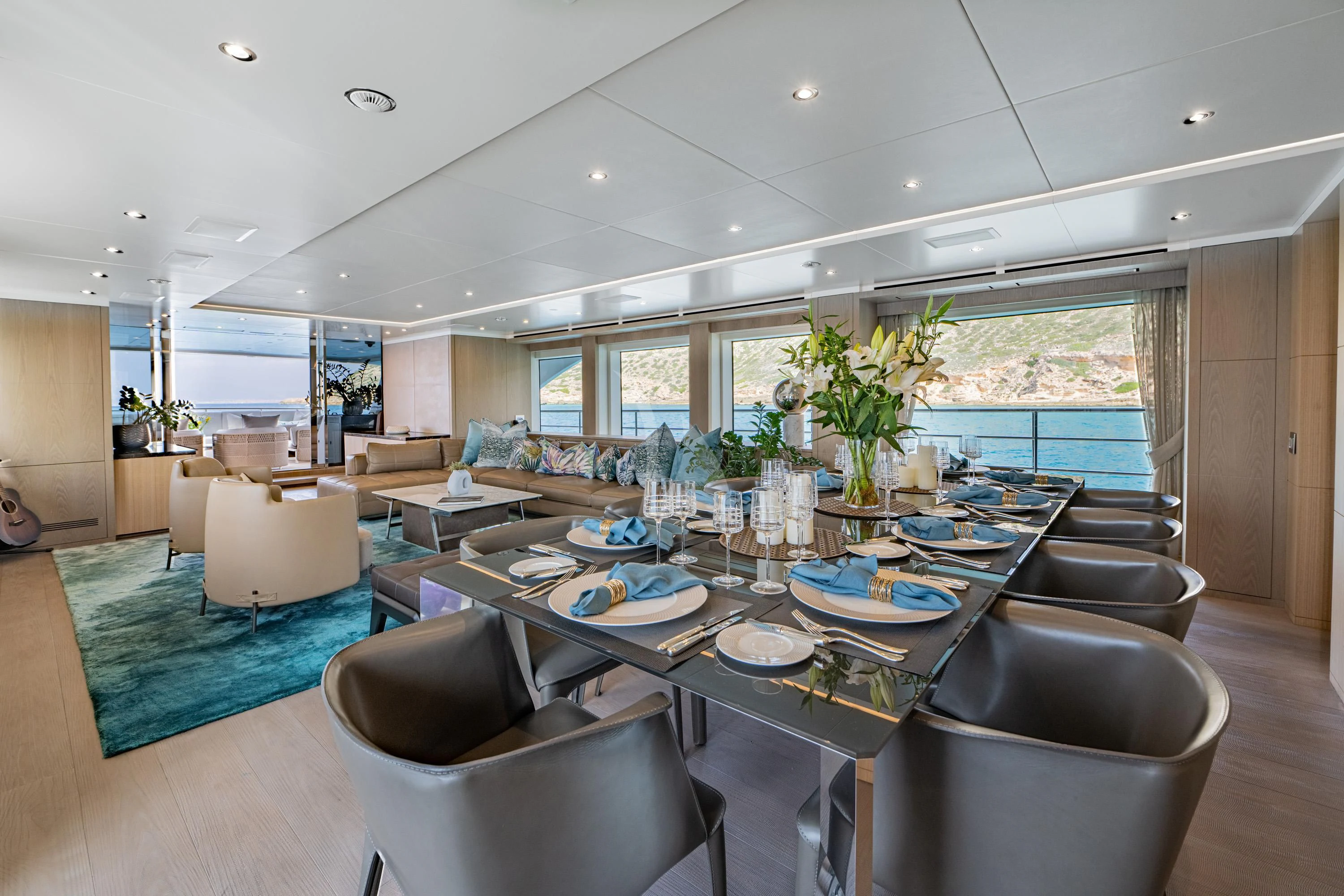 a large living room with a large table and chairs aboard ALEGRE Yacht for Sale