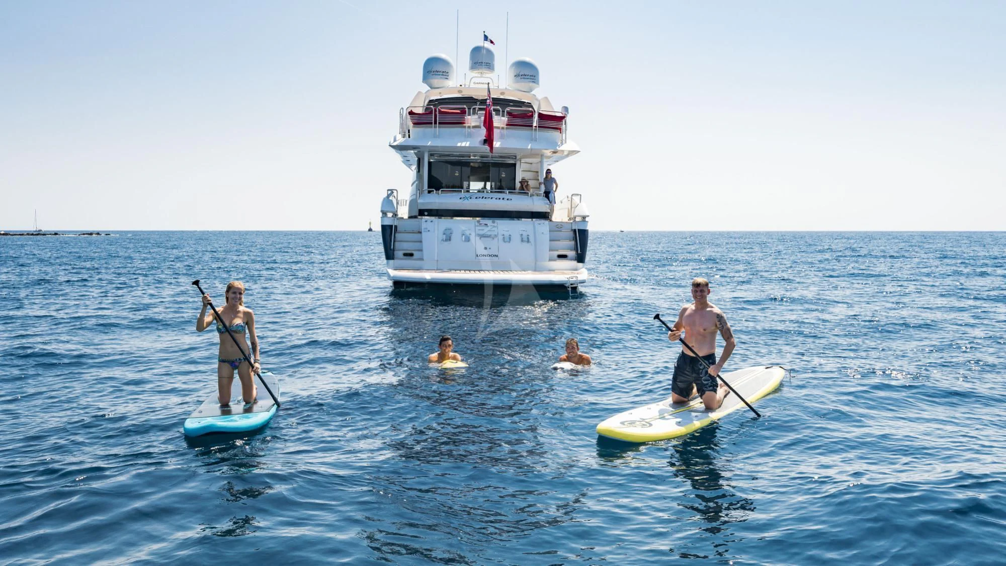 a group of people on surfboards in the ocean aboard CAPPUCCINO Yacht for Sale
