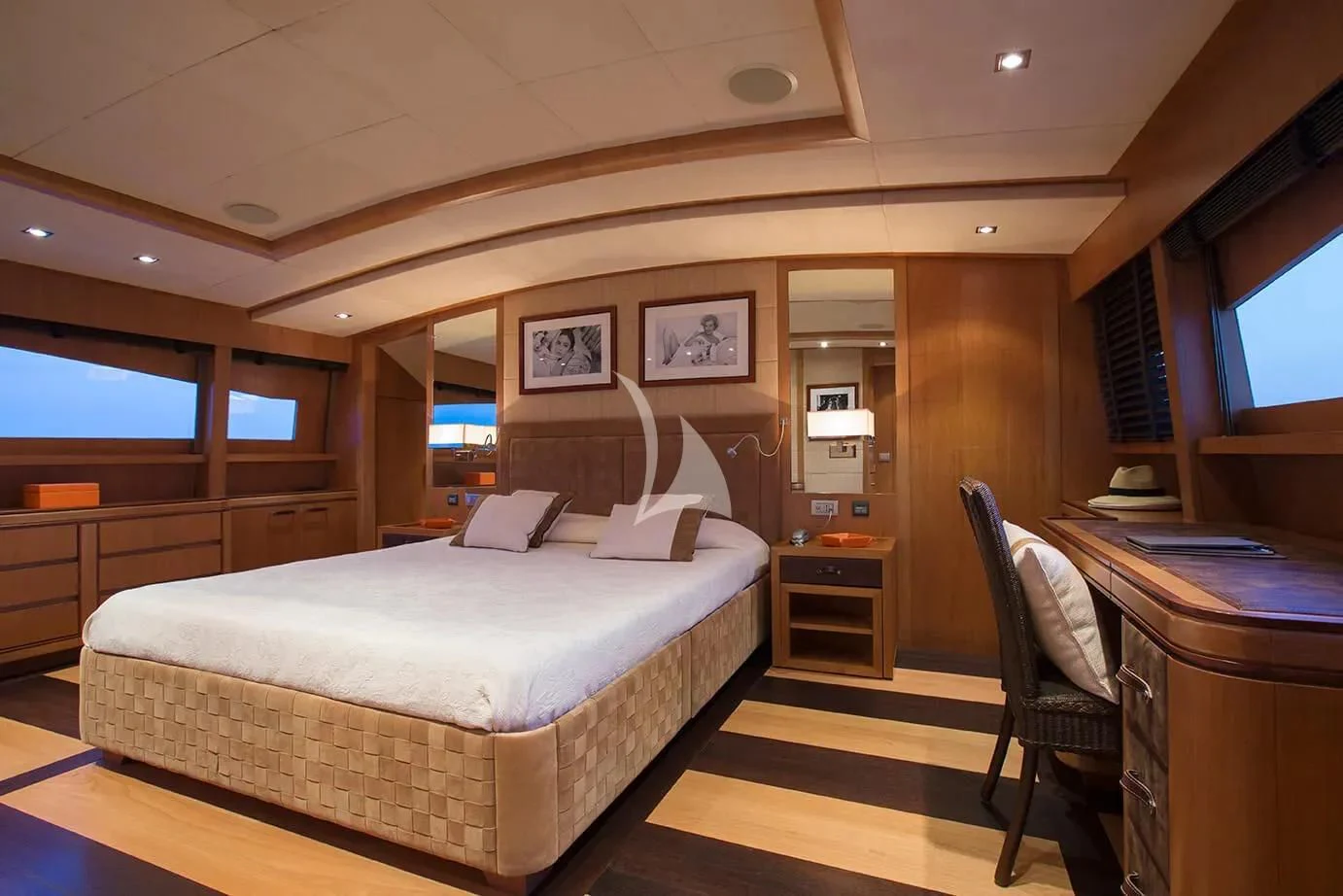 a bedroom with a bed and desk aboard CAPPUCCINO Yacht for Sale