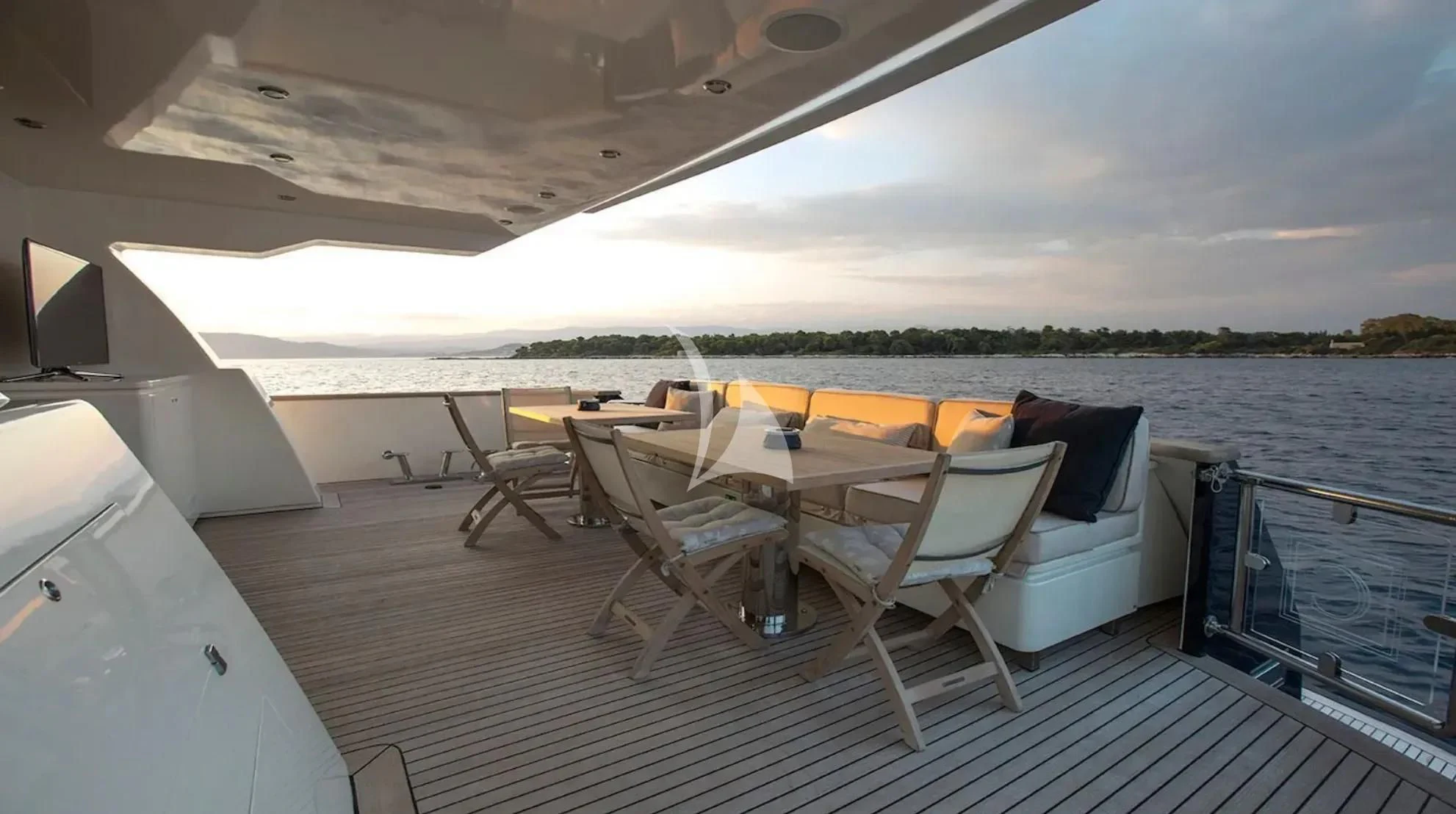 a large white lounge chair on a deck overlooking a large body of water aboard CAPPUCCINO Yacht for Sale