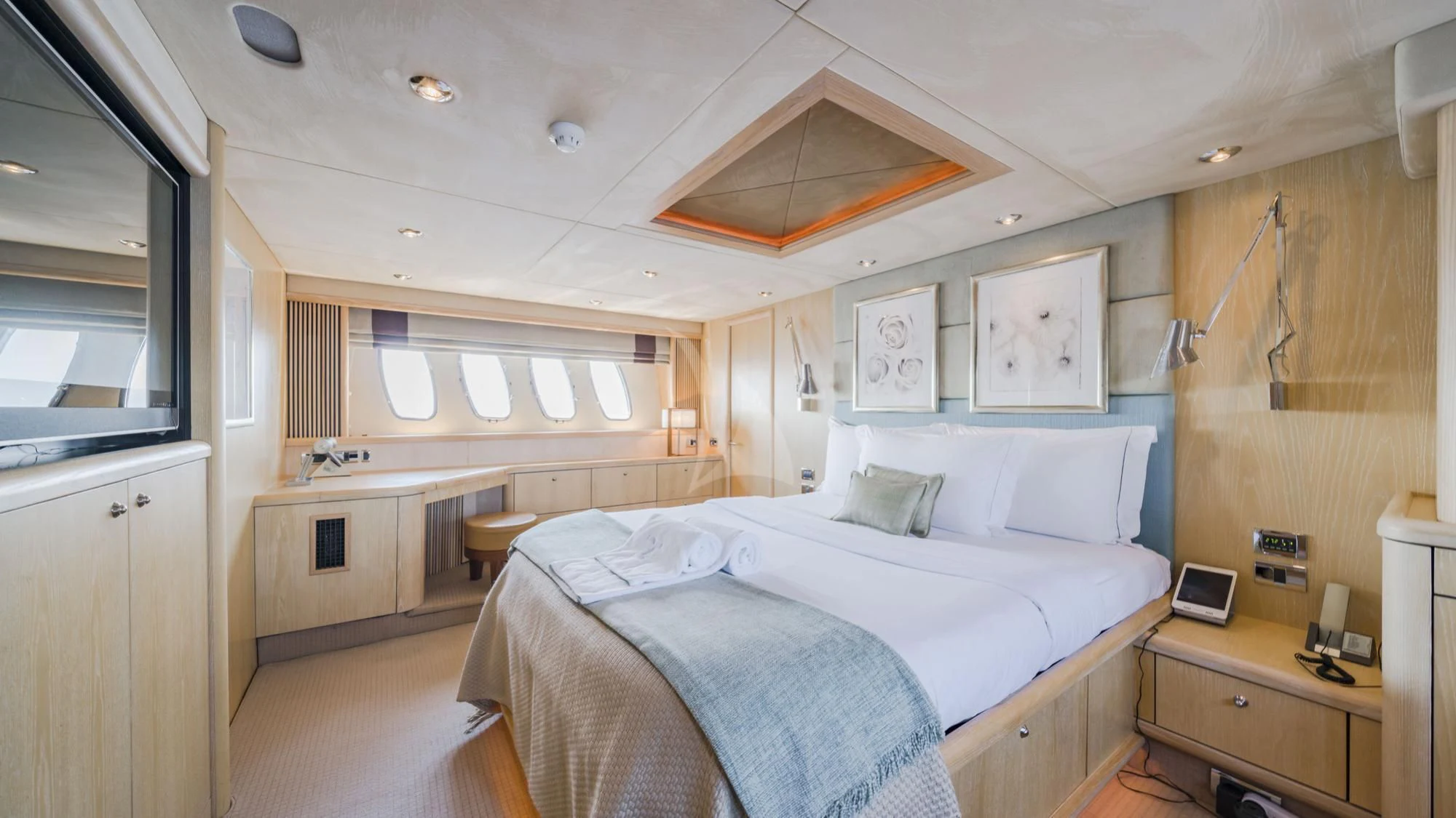 a bedroom with a bed and a desk aboard CAPPUCCINO Yacht for Sale