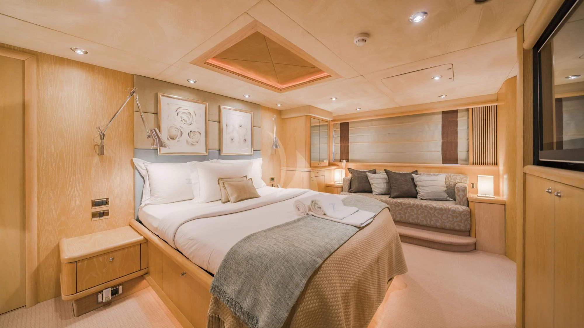 a room with a bed and a couch aboard CAPPUCCINO Yacht for Sale
