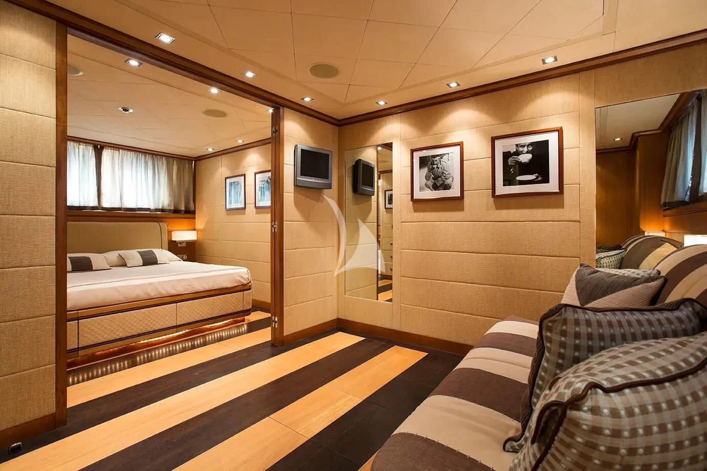 a room with a bed and a tv on the wall aboard CAPPUCCINO Yacht for Sale
