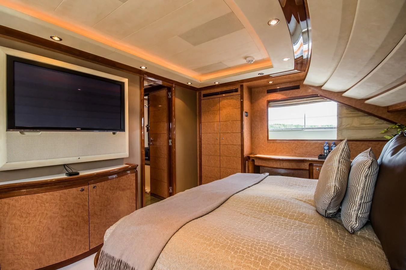 a bedroom with a bed and a tv aboard QUEEN OF SHEBA Yacht for Sale