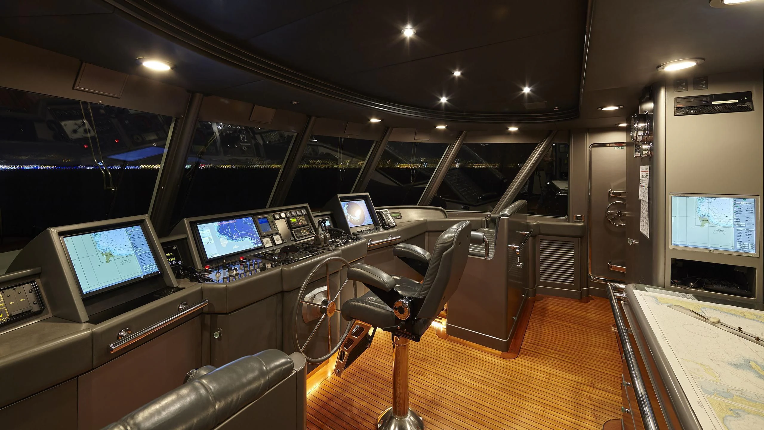 a room with computers and monitors aboard AZUL V Yacht for Charter