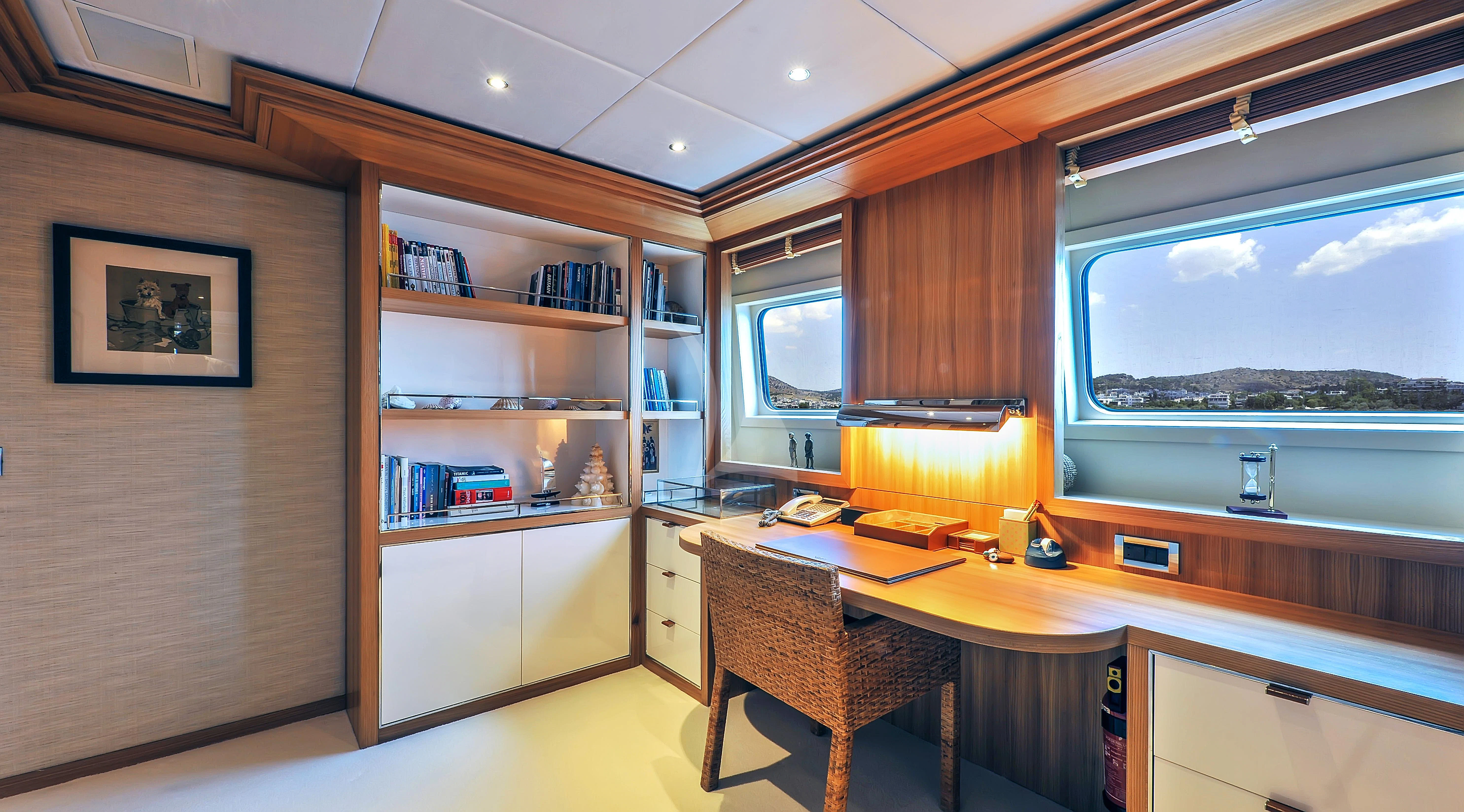 a room with a desk and a window aboard IRAVATI Yacht for Sale