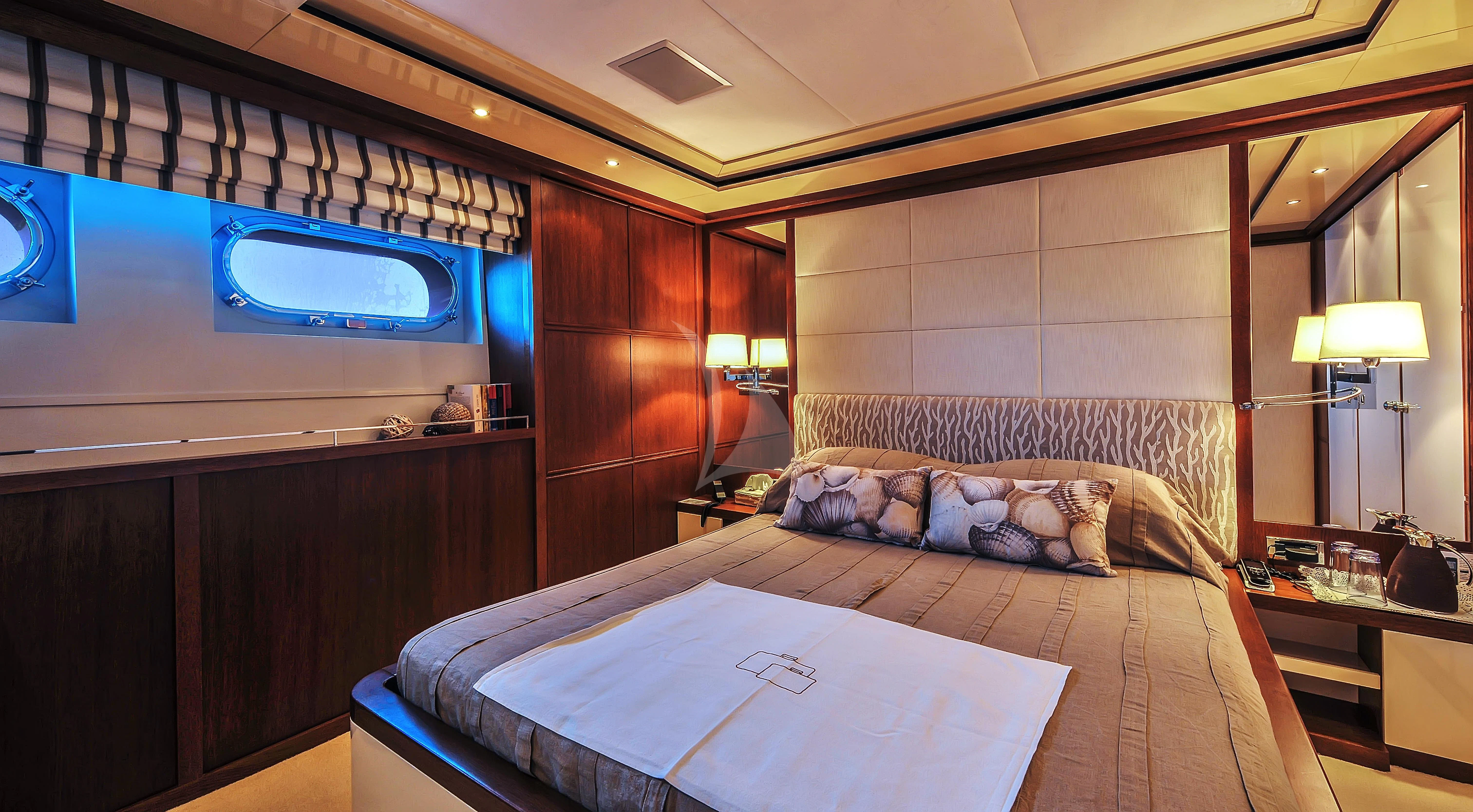 a room with a bed and a desk aboard IRAVATI Yacht for Sale