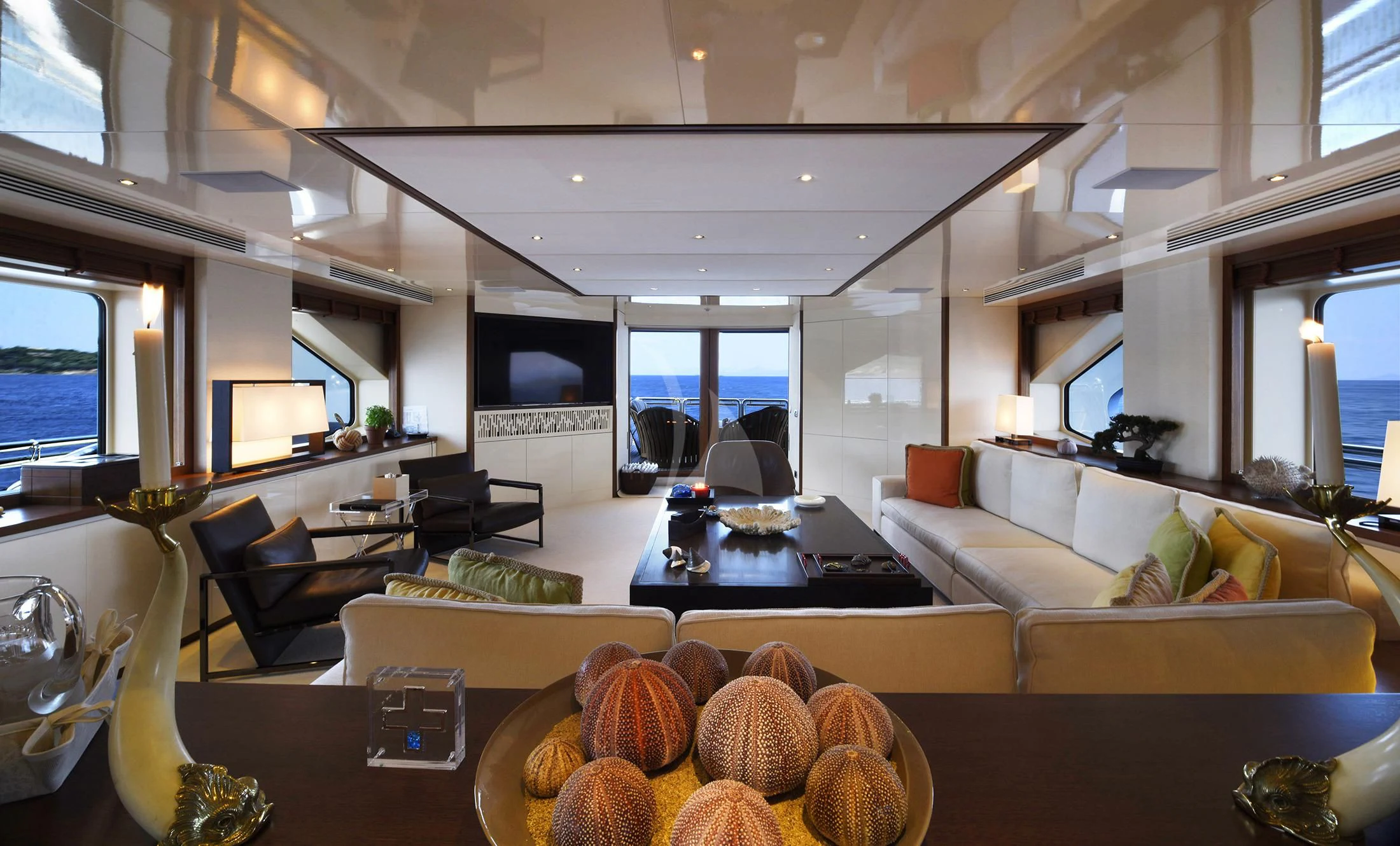 a large room with a couch and a table with pumpkins aboard IRAVATI Yacht for Sale