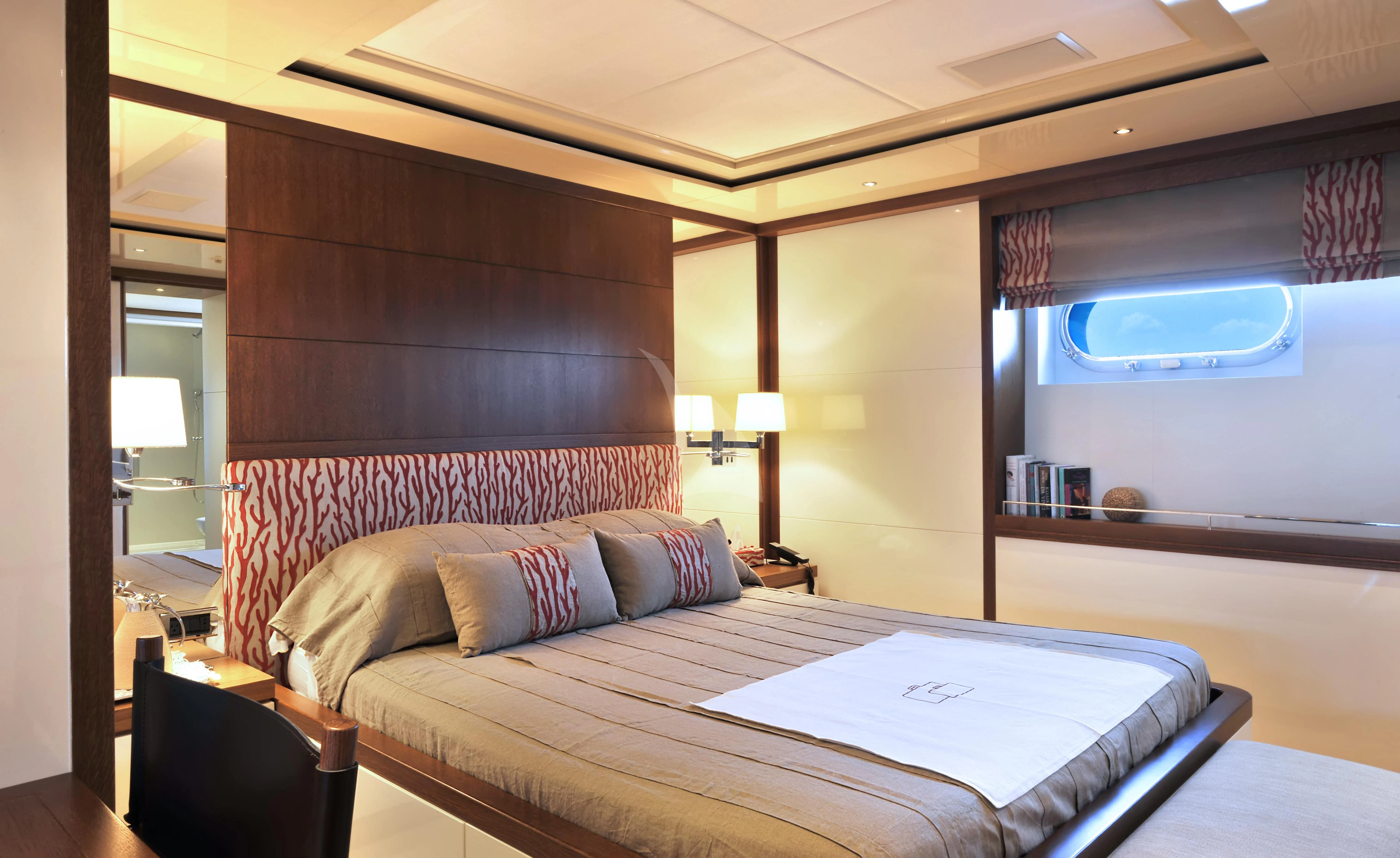 a bed with a large mirror above it aboard IRAVATI Yacht for Sale
