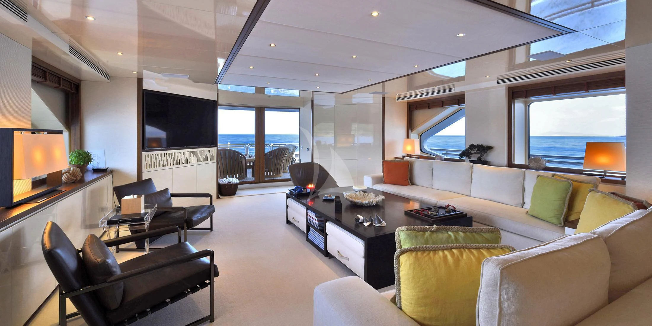 a living room with a large screen aboard IRAVATI Yacht for Sale