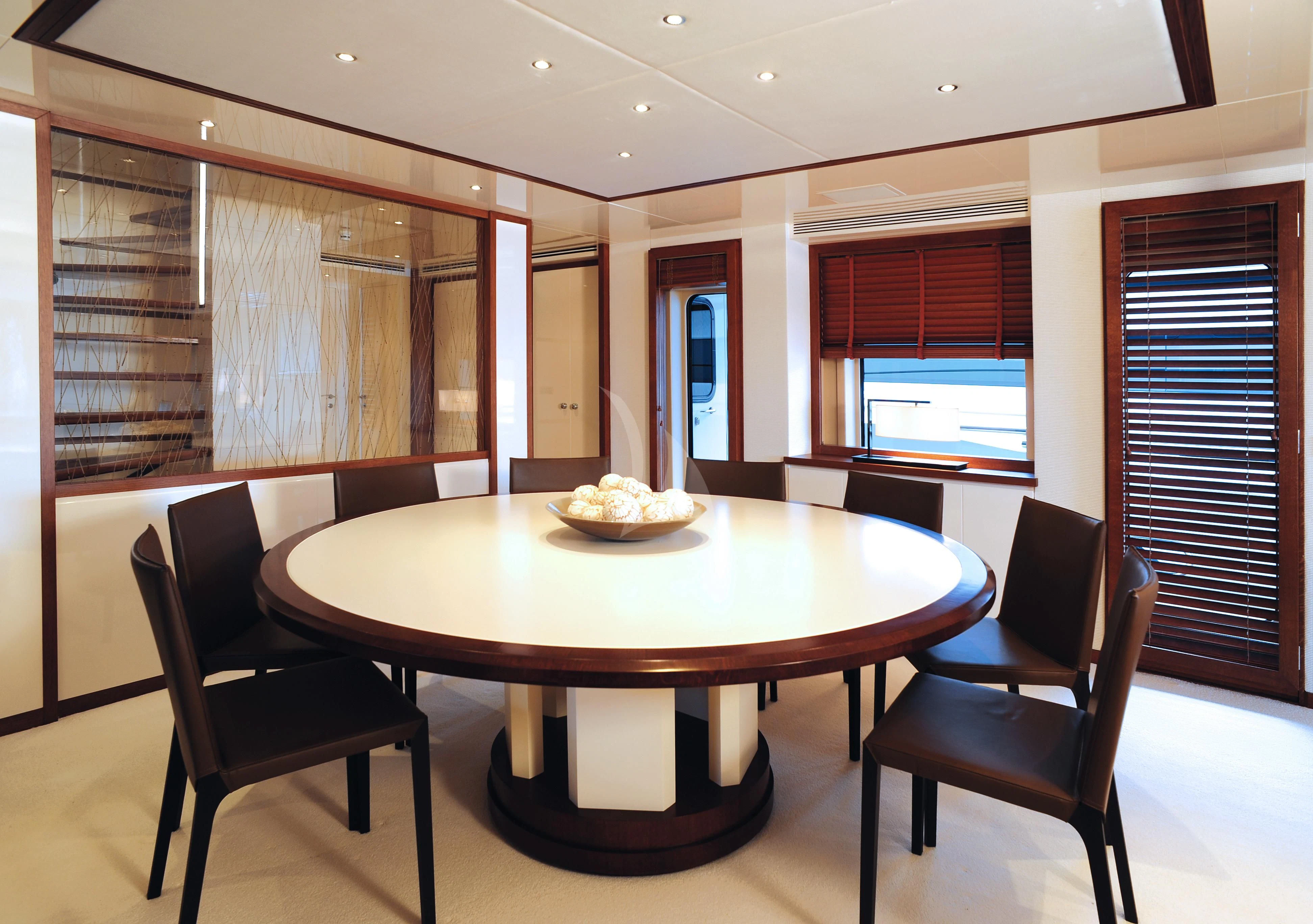 a table with chairs around it aboard IRAVATI Yacht for Sale