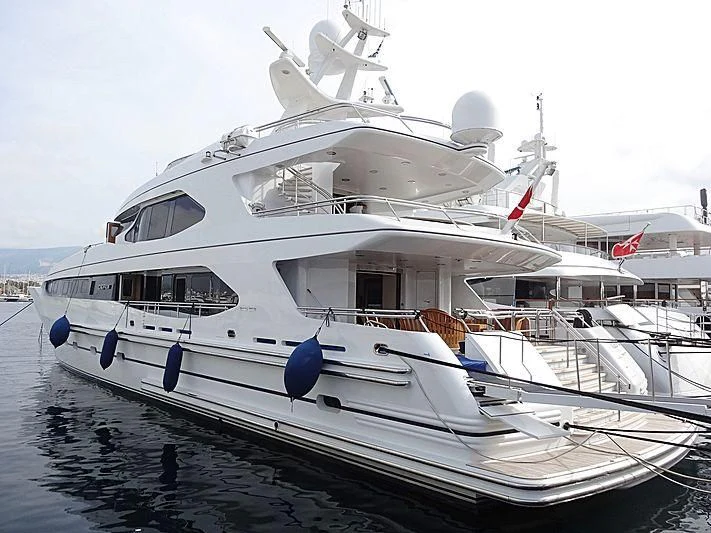 a white boat with a blue bow aboard IRAVATI Yacht for Sale