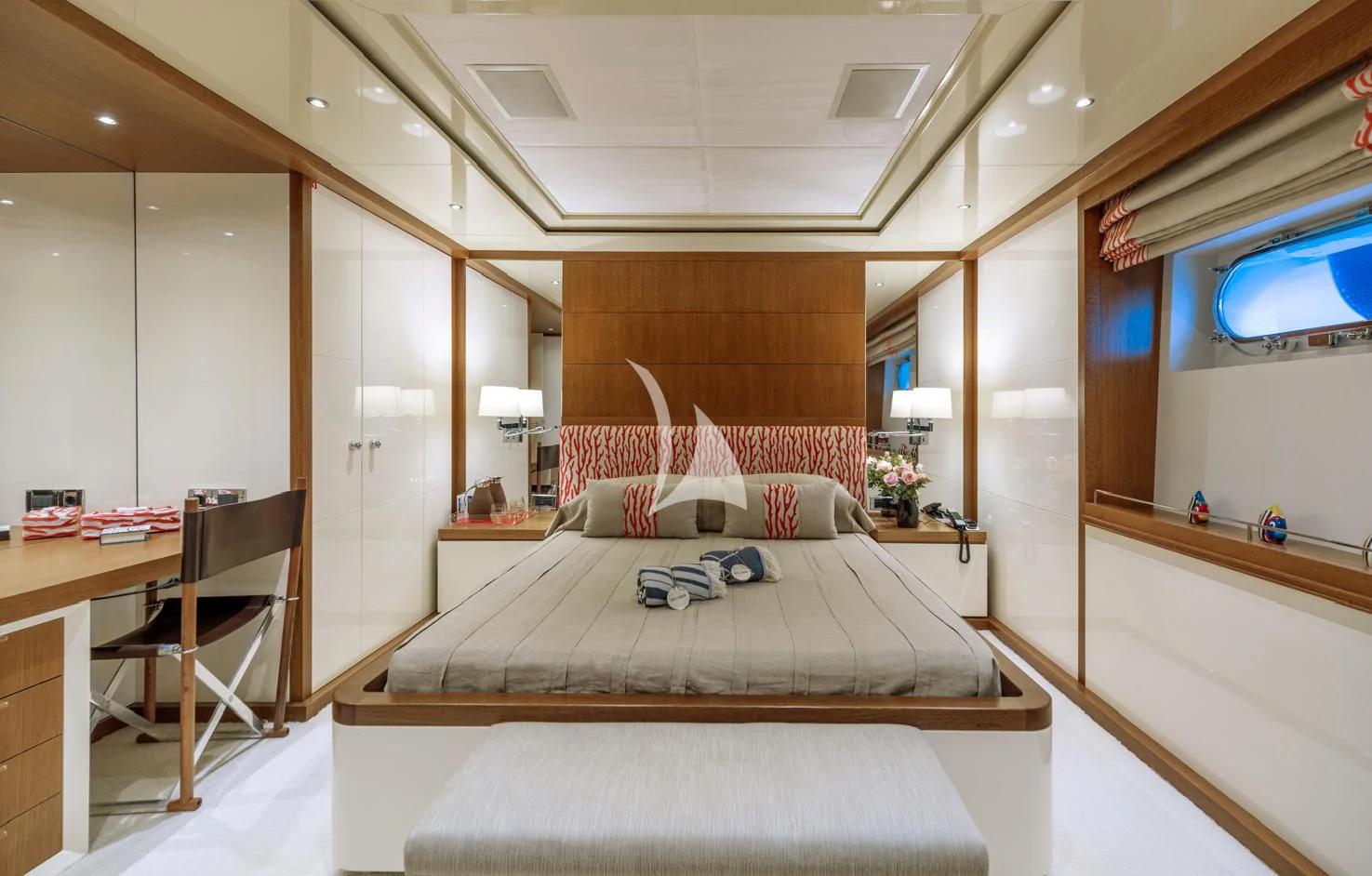 a bedroom with a bed and a desk aboard IRAVATI Yacht for Sale