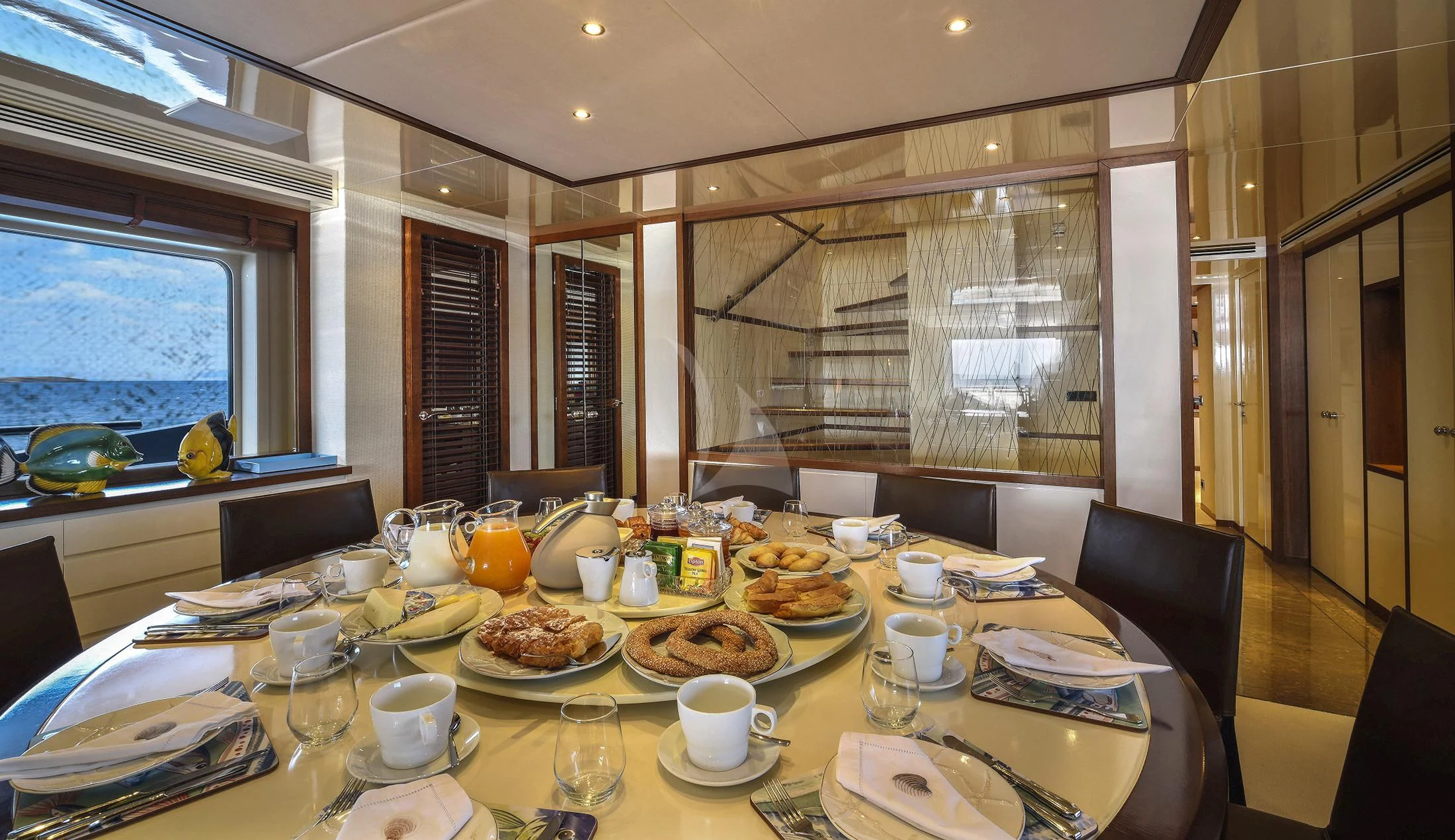 a table with plates and glasses on it aboard IRAVATI Yacht for Sale