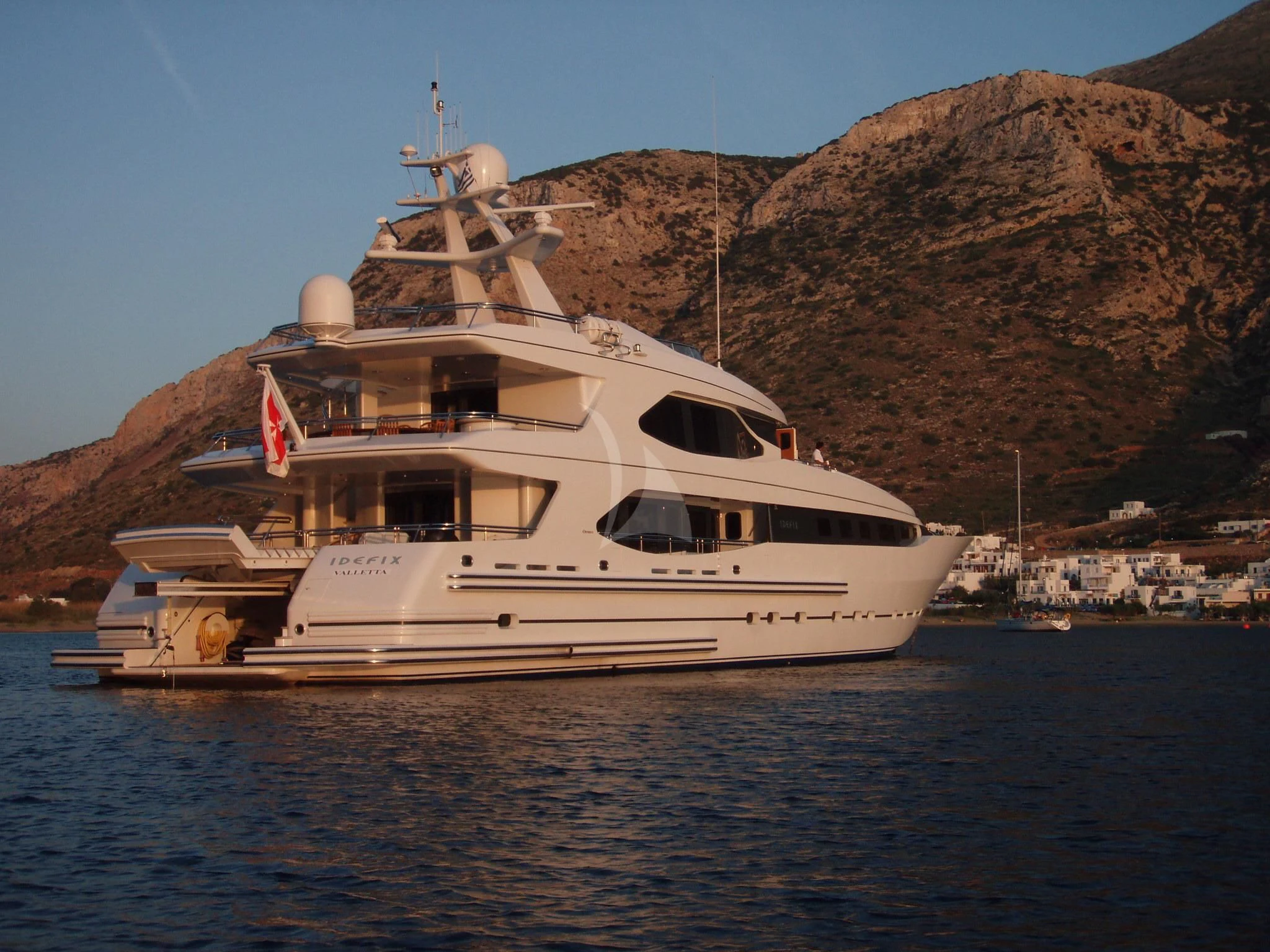 a large white boat on the water aboard IRAVATI Yacht for Sale