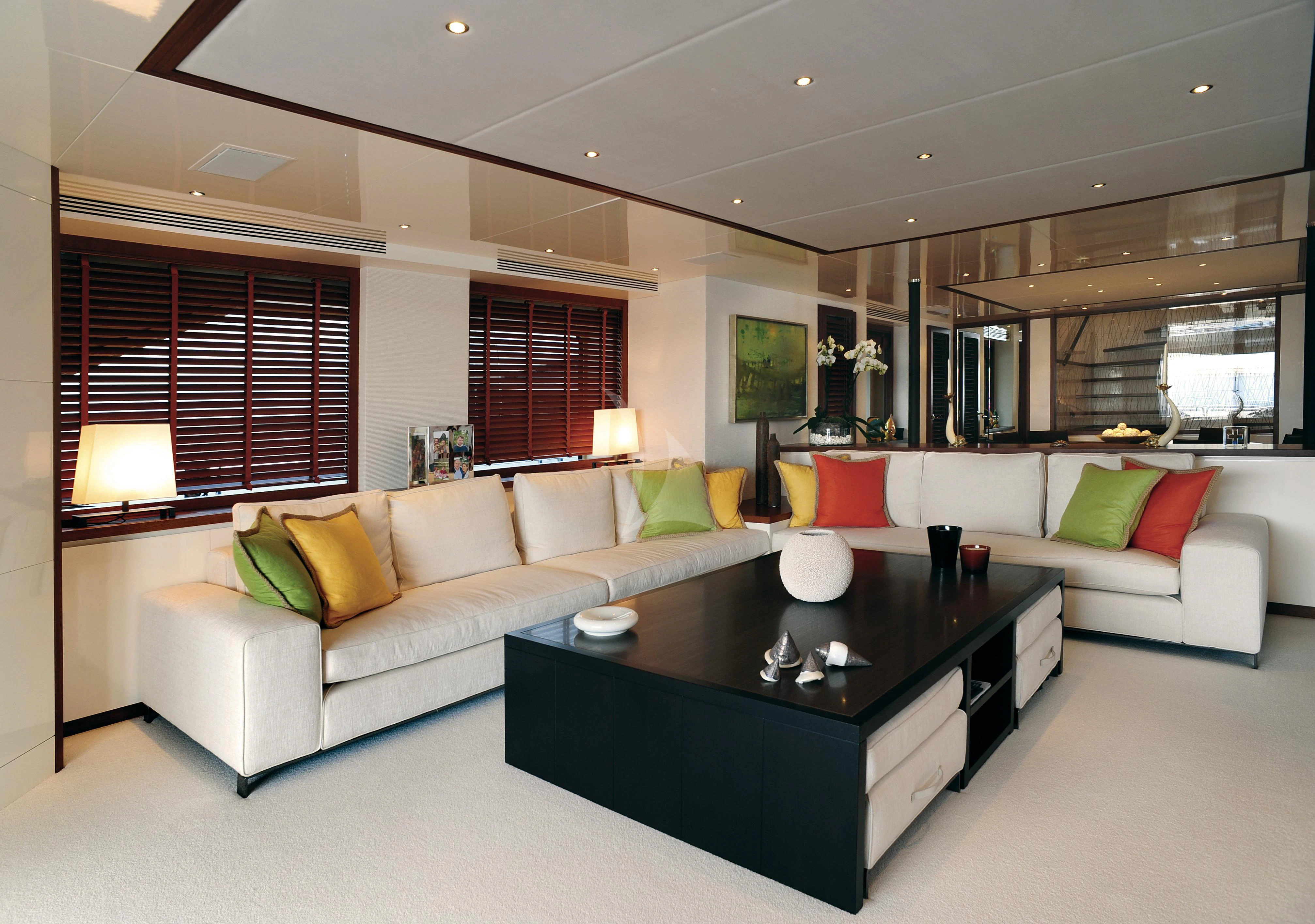 a living room with a couch and a coffee table aboard IRAVATI Yacht for Sale