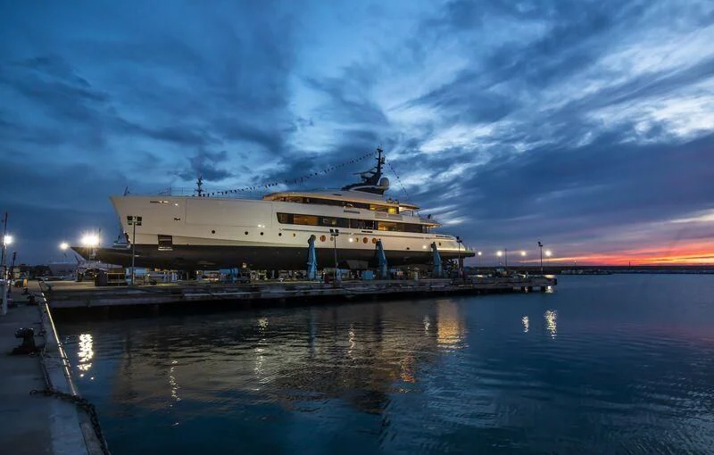 a large cruise ship docked at a pier at night aboard BRAVISSIMA Yacht for Sale
