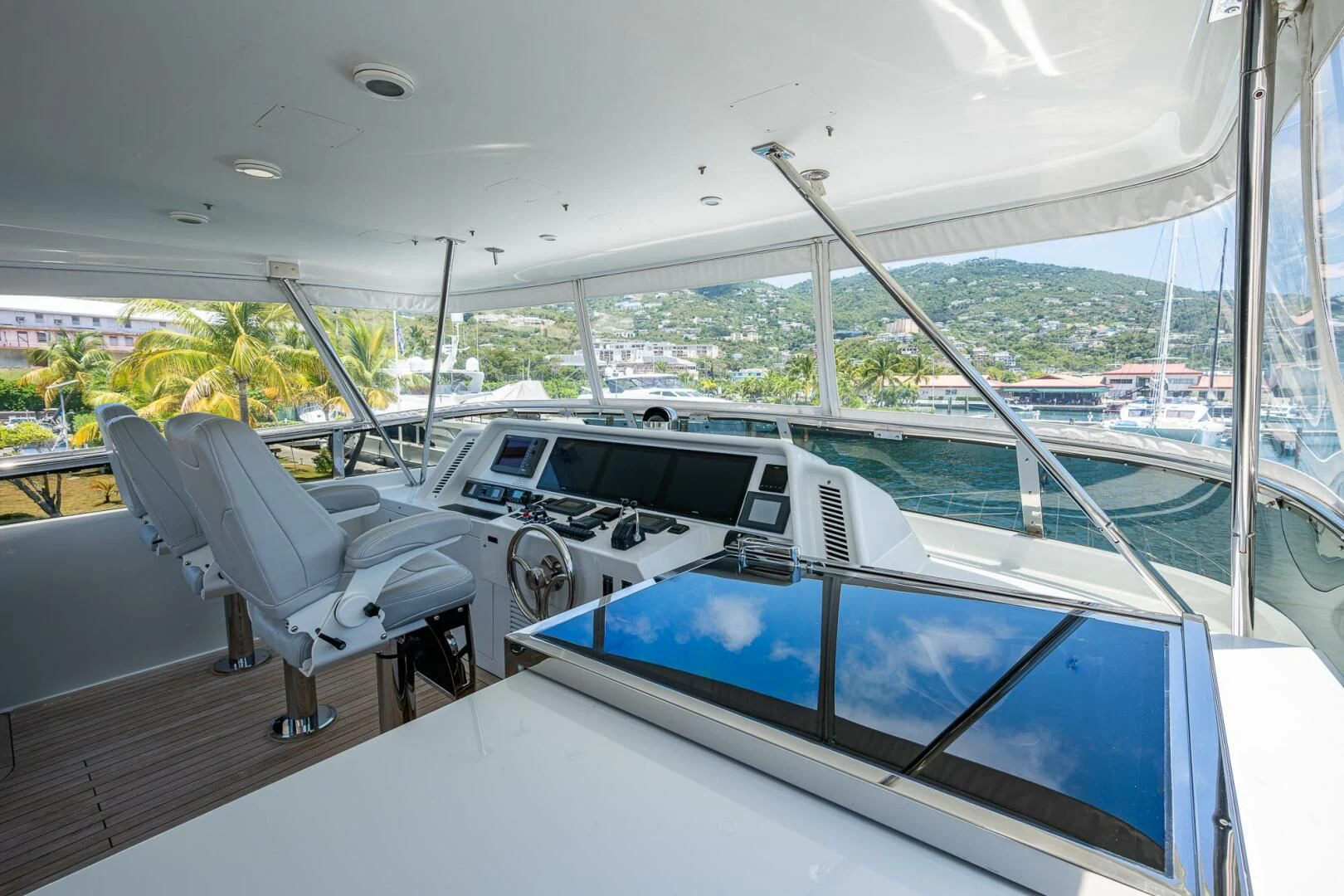 a room with a large pool and a large window with a view of the city aboard LADY LORRAINE Yacht for Sale