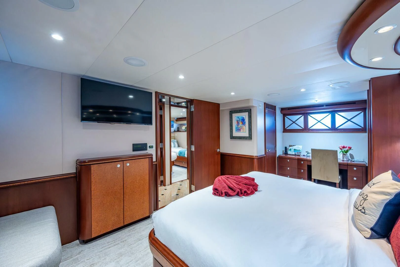 a bedroom with a bed and a television aboard LADY LORRAINE Yacht for Sale