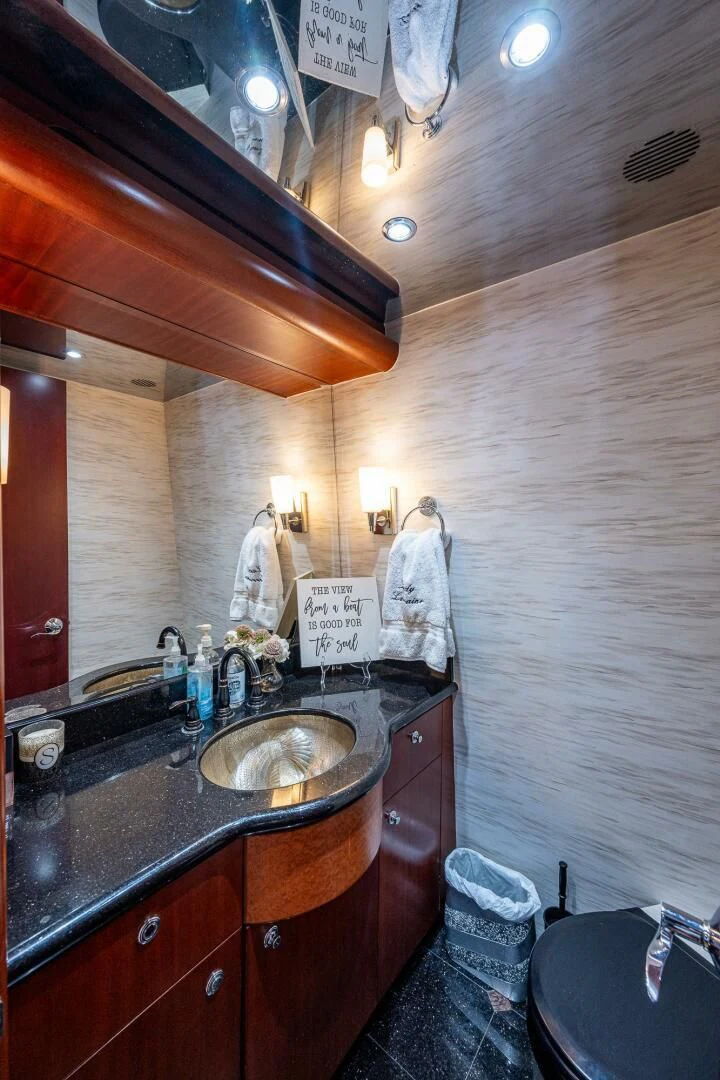a bathroom with a sink and a mirror aboard LADY LORRAINE Yacht for Sale