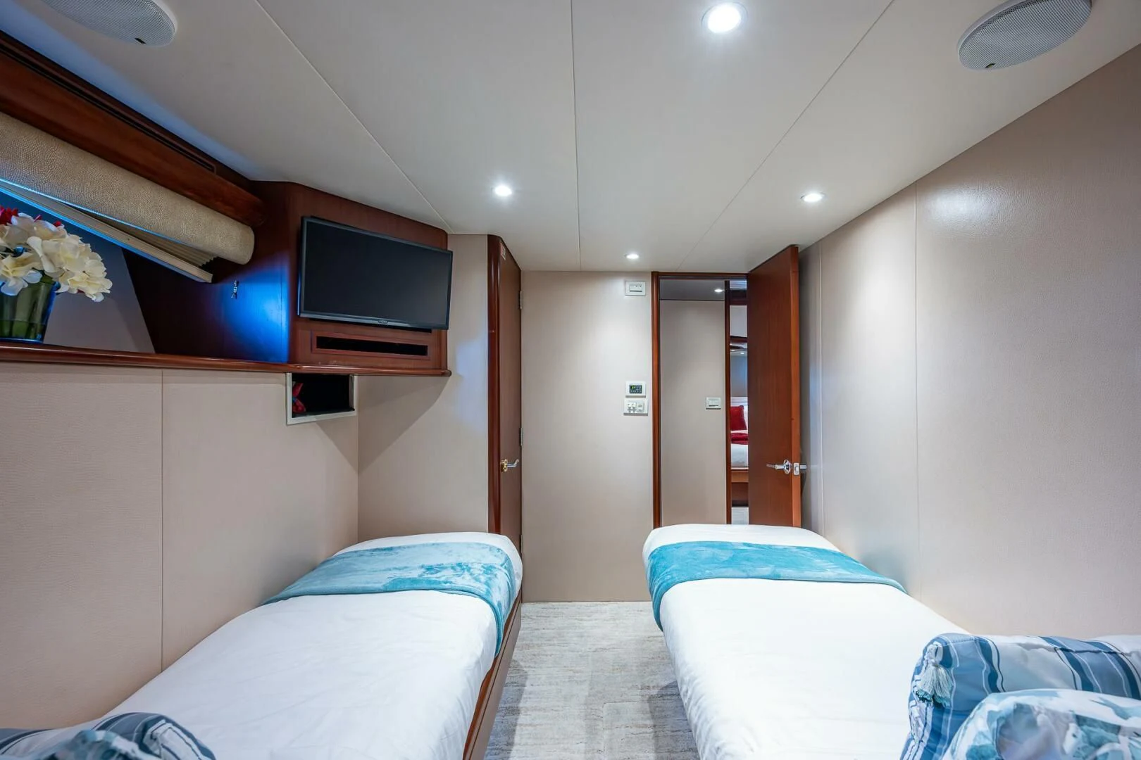 a room with two beds and a tv on the wall aboard LADY LORRAINE Yacht for Sale