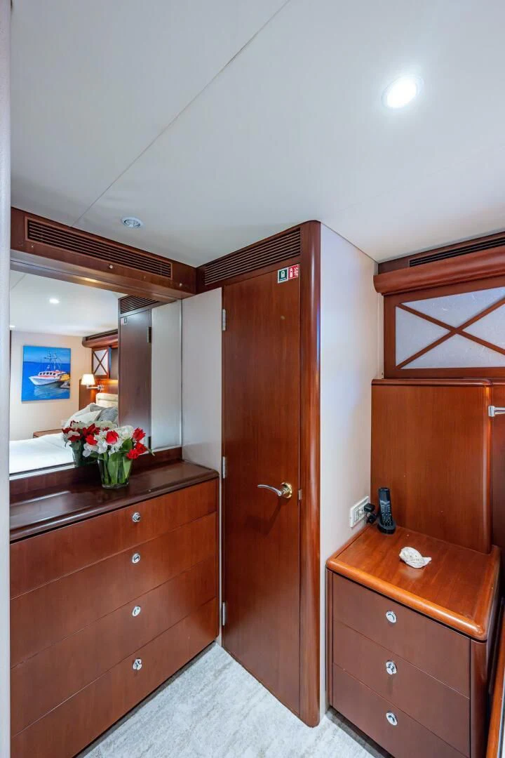 a bathroom with a wood cabinet and a mirror aboard LADY LORRAINE Yacht for Sale