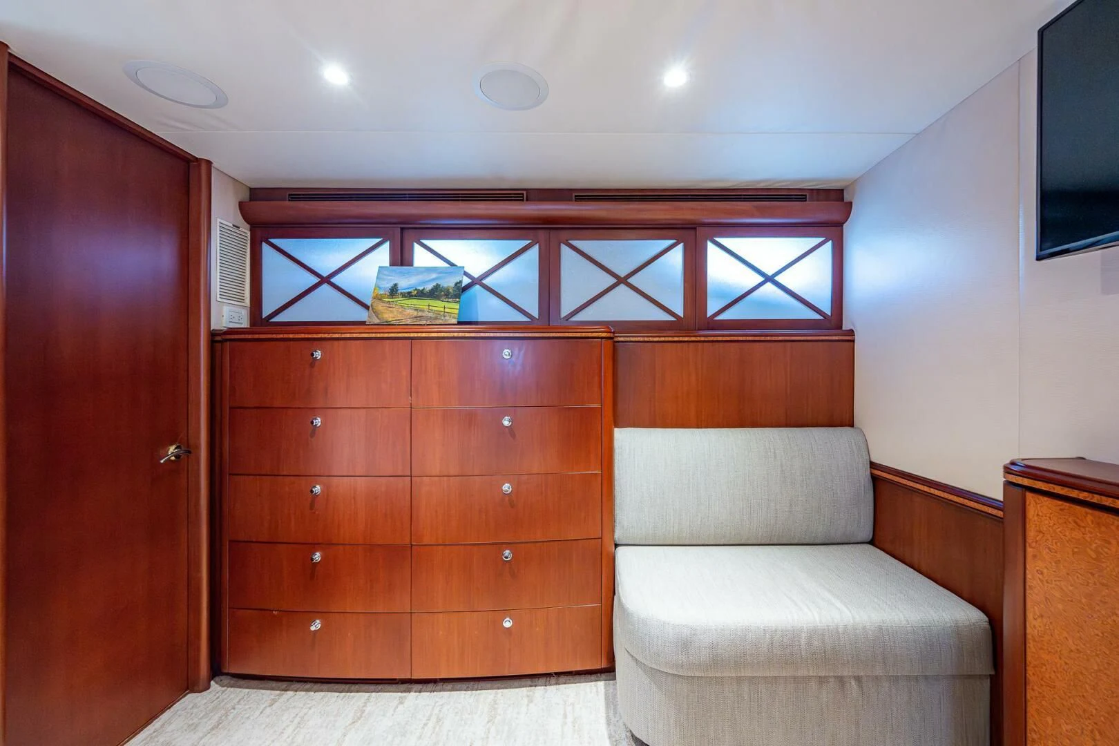 a room with a couch and a dresser aboard LADY LORRAINE Yacht for Sale