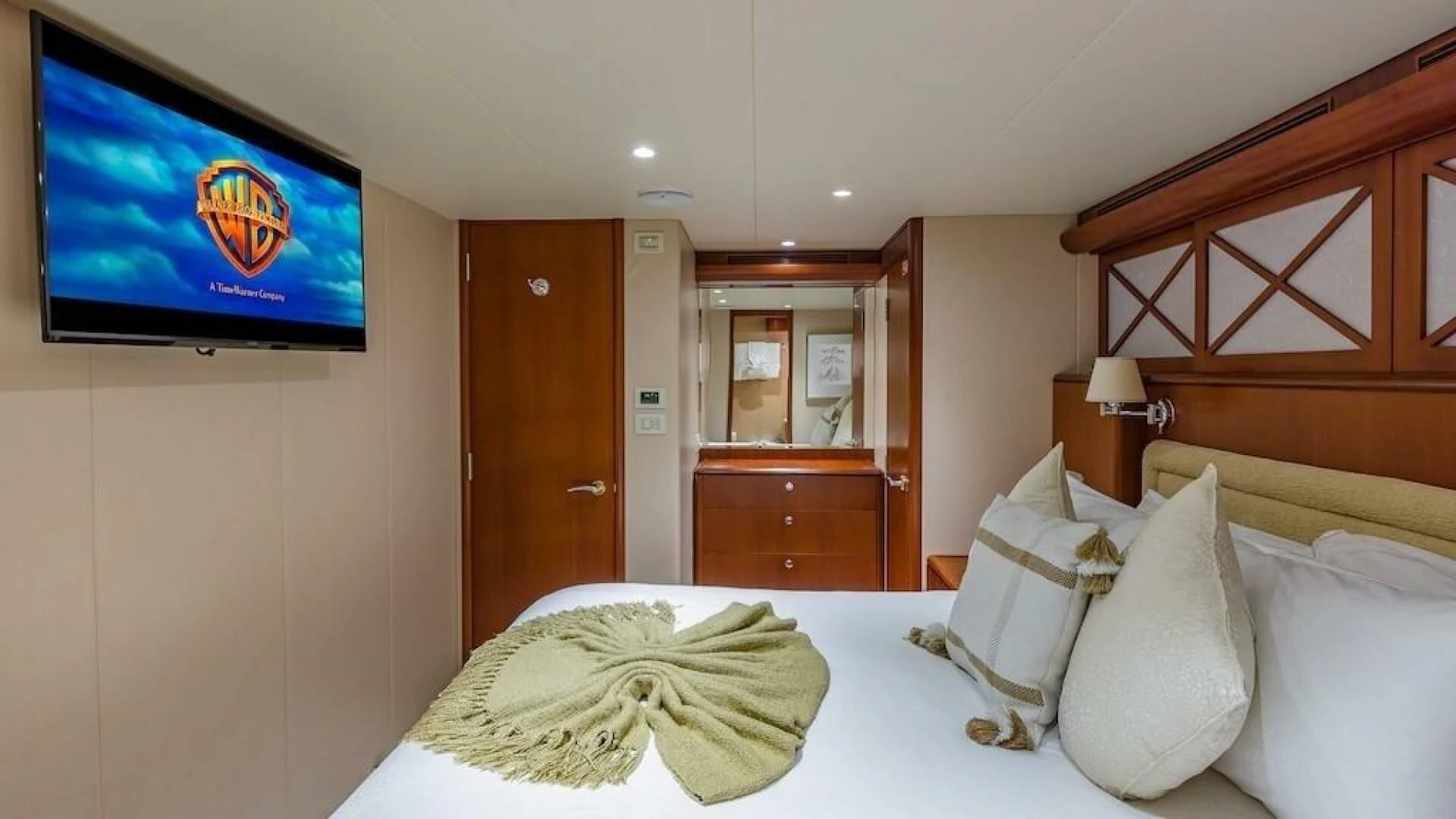 a hotel room with a bed and tv aboard LADY LORRAINE Yacht for Sale