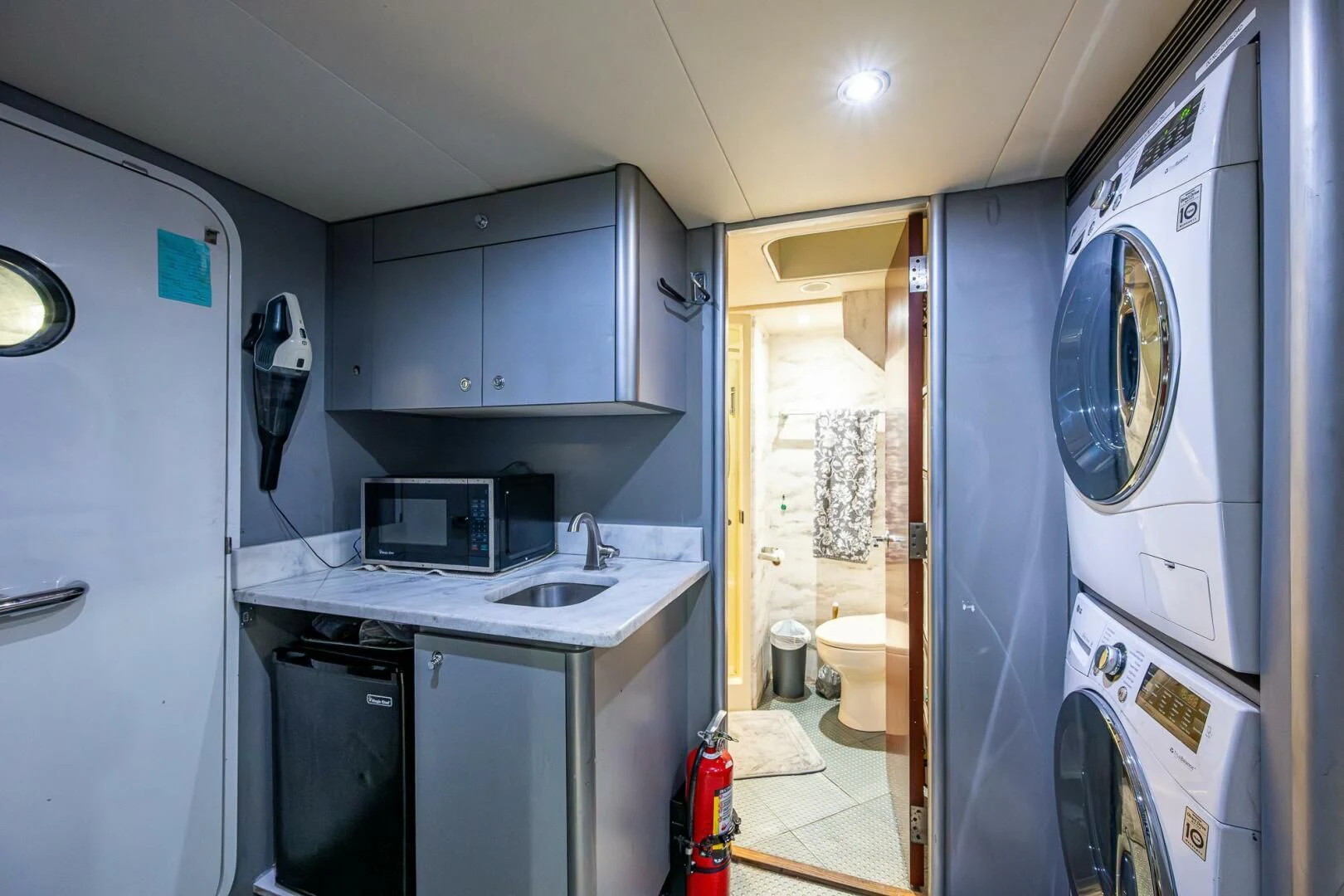 a small kitchen with a washing machine aboard LADY LORRAINE Yacht for Sale