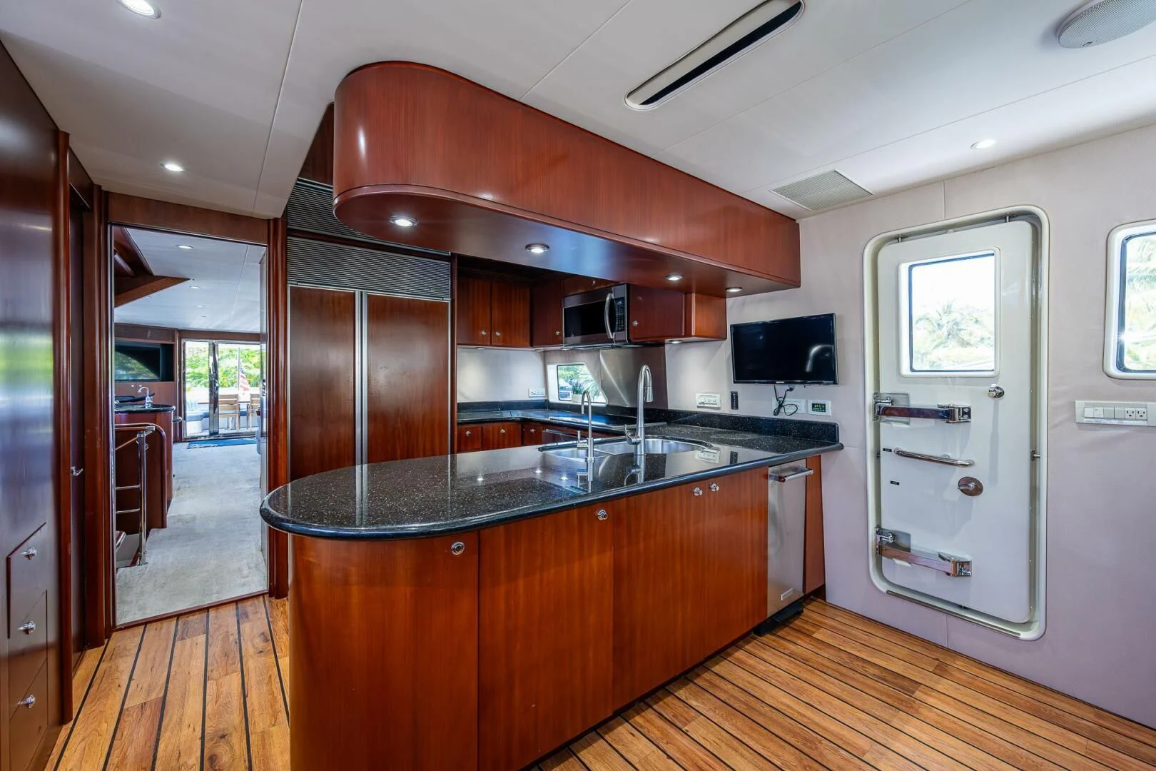a kitchen with wooden cabinets aboard LADY LORRAINE Yacht for Sale