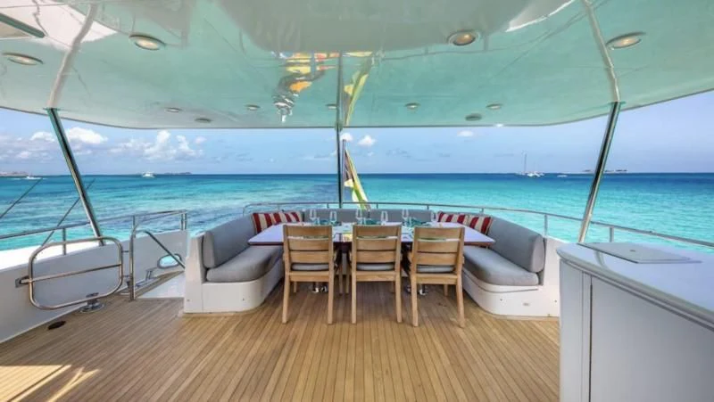 a table and chairs on a deck aboard LADY LORRAINE Yacht for Sale
