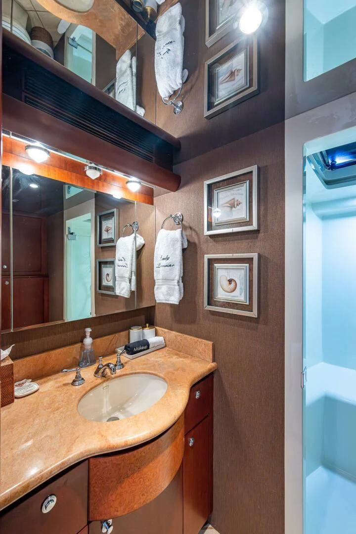 a bathroom with a sink and mirror aboard LADY LORRAINE Yacht for Sale