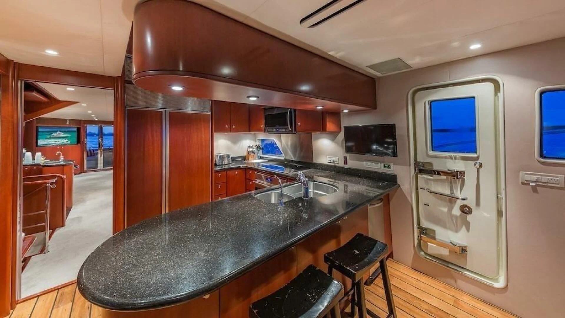 a kitchen with a bar and a large island aboard LADY LORRAINE Yacht for Sale