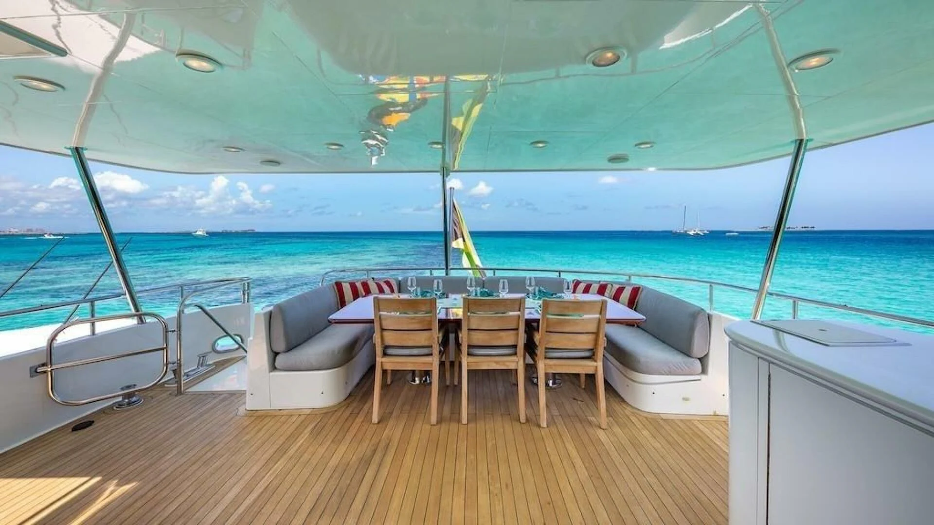 a deck with a table and chairs on it aboard LADY LORRAINE Yacht for Sale